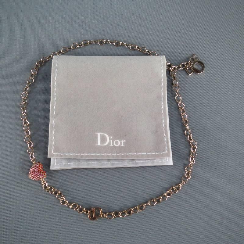 Fabulous sweetheart charm bracelet by DIOR. This style features a silver tone cutout heart chain with 