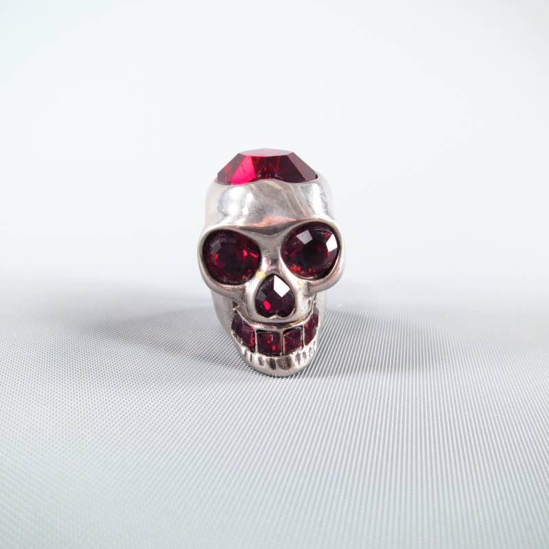 Fabulous statement ring by ALEXANDER MCQUEEN. A signature style featuring a large silver tone skull with ruby red crystal details and a large heart on top. This piece includes original box with certificate of authenticity. Mae in Italy.
