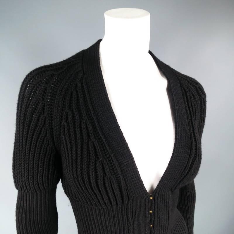Fabulous Lana wool cardigan by GUCCI. This ultra chic style features a deep V neckline, unique Juliet puff to fitted long sleeve, and fitted corset like body with gold hook eye closure. Made in Italy.
 
Excellent Pre-Owned Condition.
 
Shoulder: