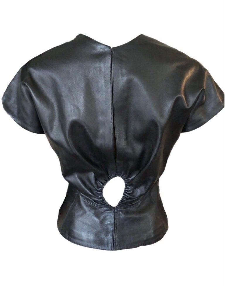 Azzedine Alaia Sexy Cutout Leather Top

Black Alaïa leather top with tonal stitching throughout, cap sleeves, plunging neckline and hook-and-eye closures at back.

All Eyes on Alaïa

For the last half-century, the world’s most fashionable and