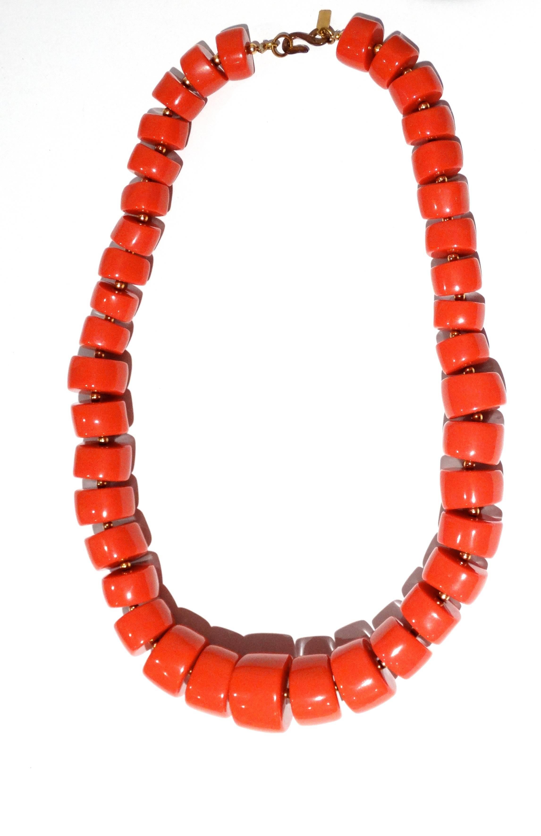 This is a big, bold, beaded necklace by Kenneth (Jay) Lane circa 1980's. The necklace consists of 40 small to large, smooth, solid coral colored resin beads, each measuring between 1/2 