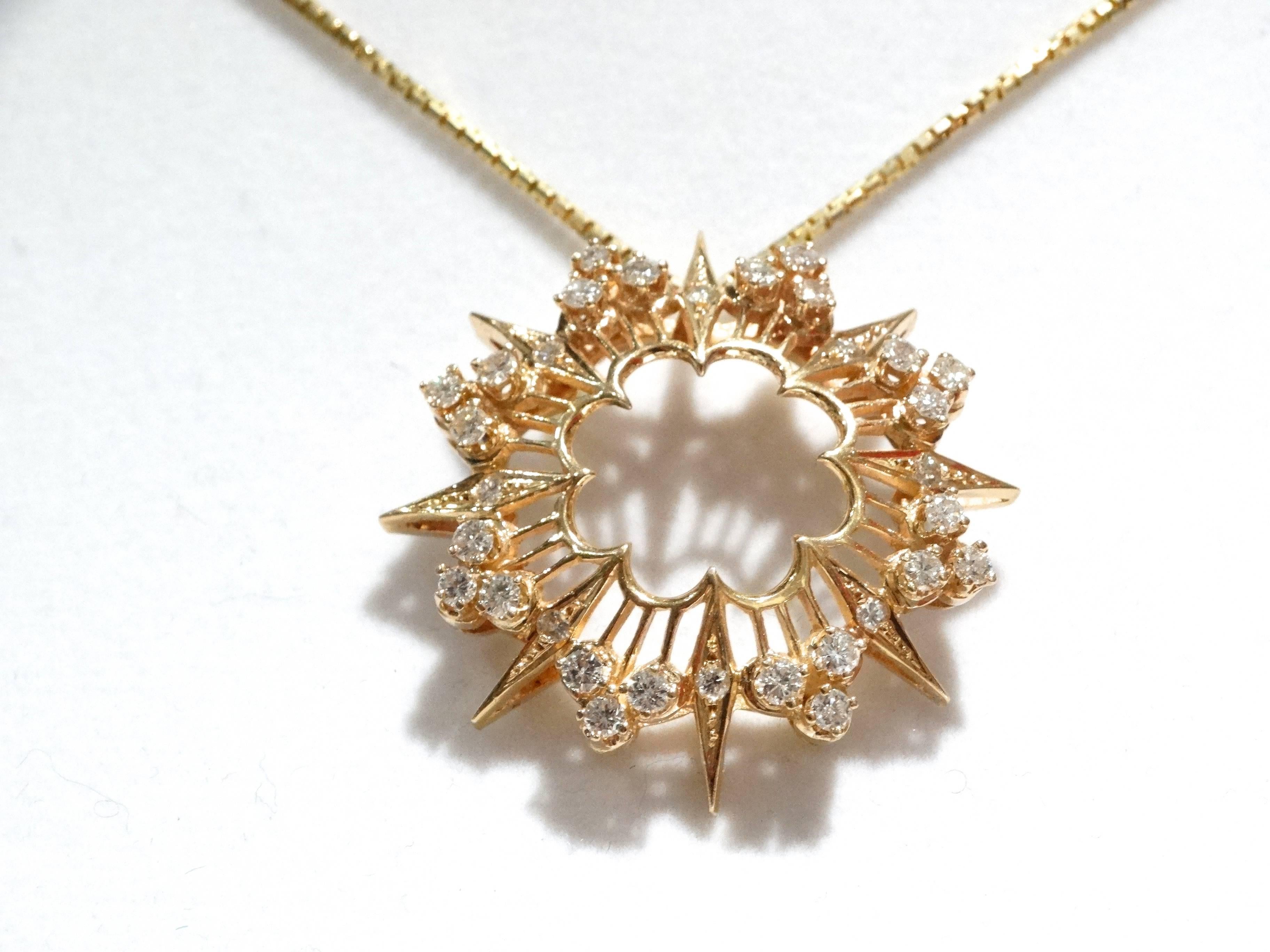 A beautiful 1970's 14kt yellow gold fancy sunburst pendent containing twenty-four (24) brilliant cut diamonds weighing approximately 1.20cts. Total weight and eight (8) brilliant cut diamonds weighing approximately .20cts total weight. All diamonds