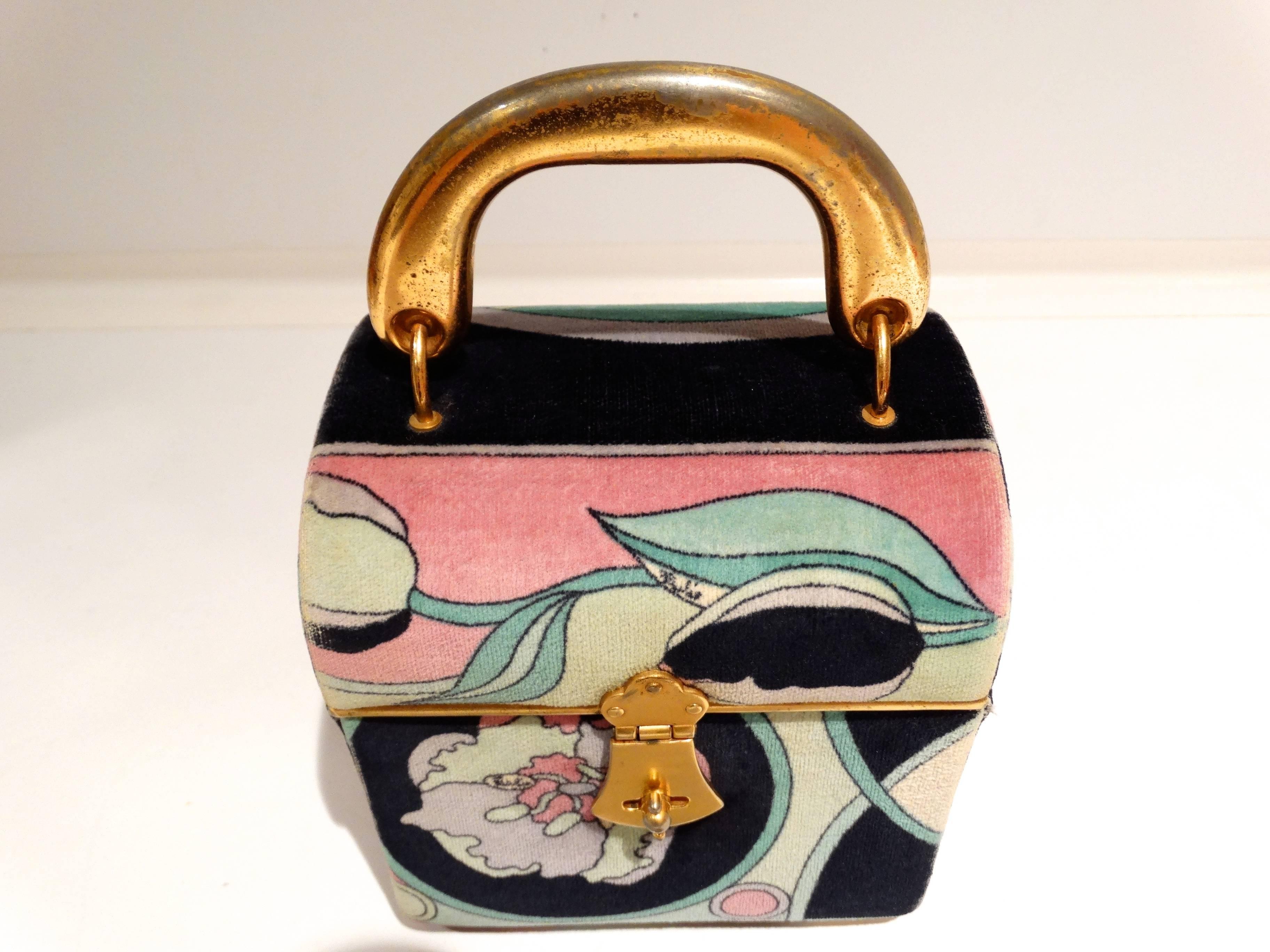Pucci Velveteen Small Box Bag, 1969. Casket shape, with rigid flat gilt-metal handle, suitcase lock, printed with a floral pattern in shades of turquoise, black, putty and lilac. Inside is lined in light purple leather, labeled: Emilio