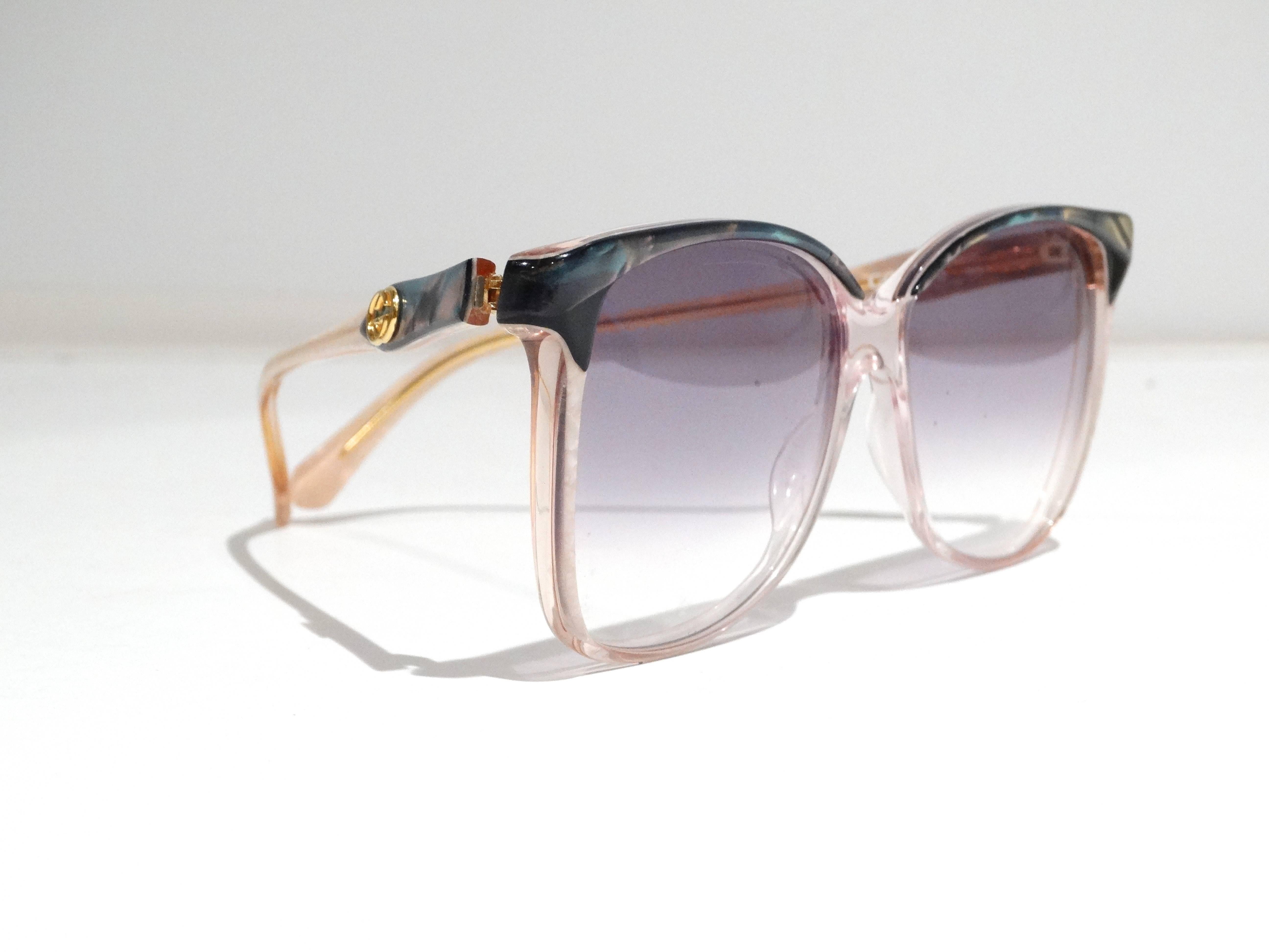 Stunning 1970's mother of pearl glasses by Gucci. Glasses feature an oversized frame with Gucci logos at sides. These have been re-lensed with a gradient sunglass lens. Also included the original clear lenses and leather Gucci sunglass sleeve.