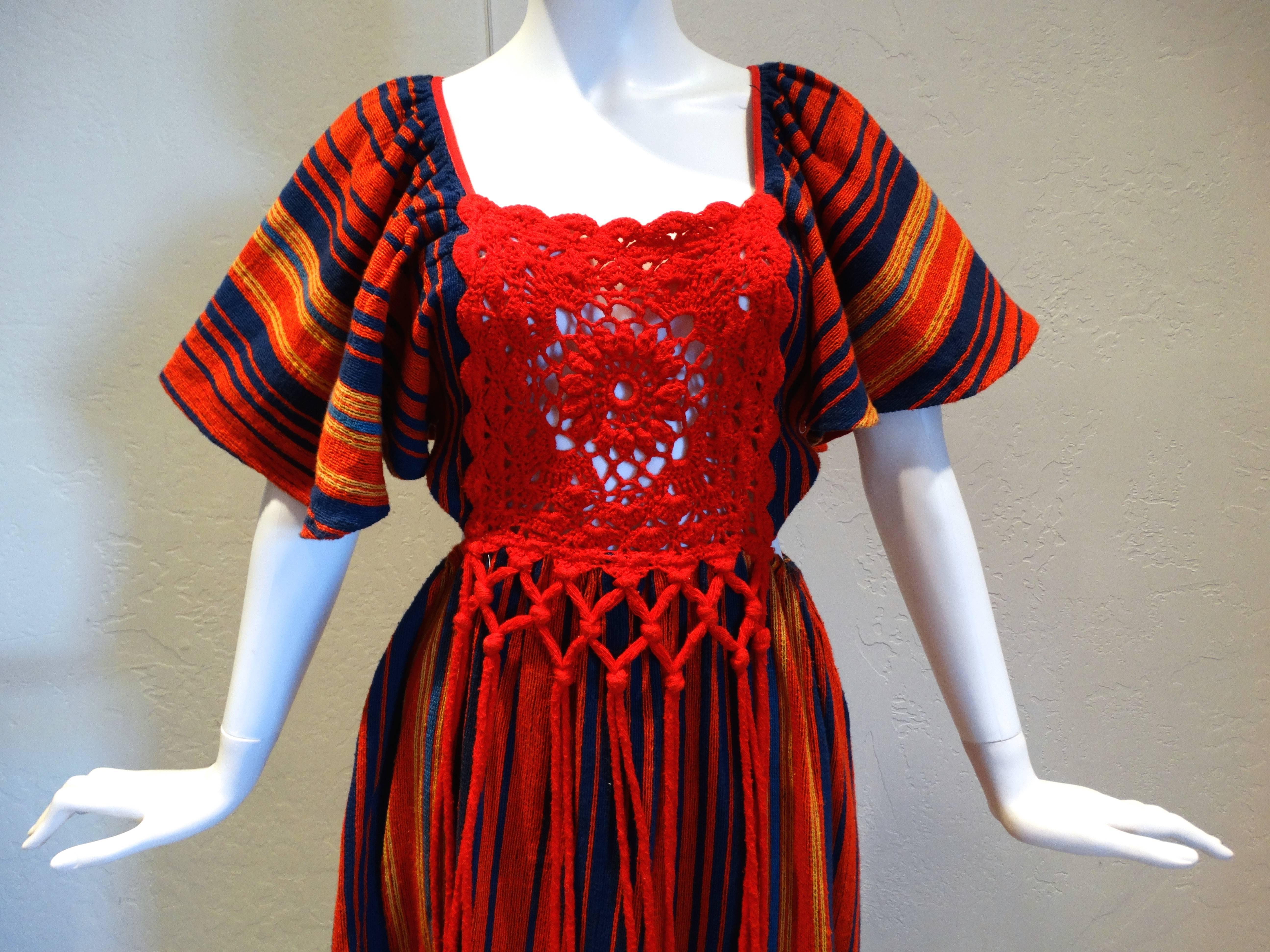 This is a true, vintage bohemian dress!!! Made in Israel from designer Rikma. The fabric is 100% woven cotton. It's done in bright stripes of reds, to light yellow and royal blue. The front of bodice is done in red, cotton crochet that is daringly