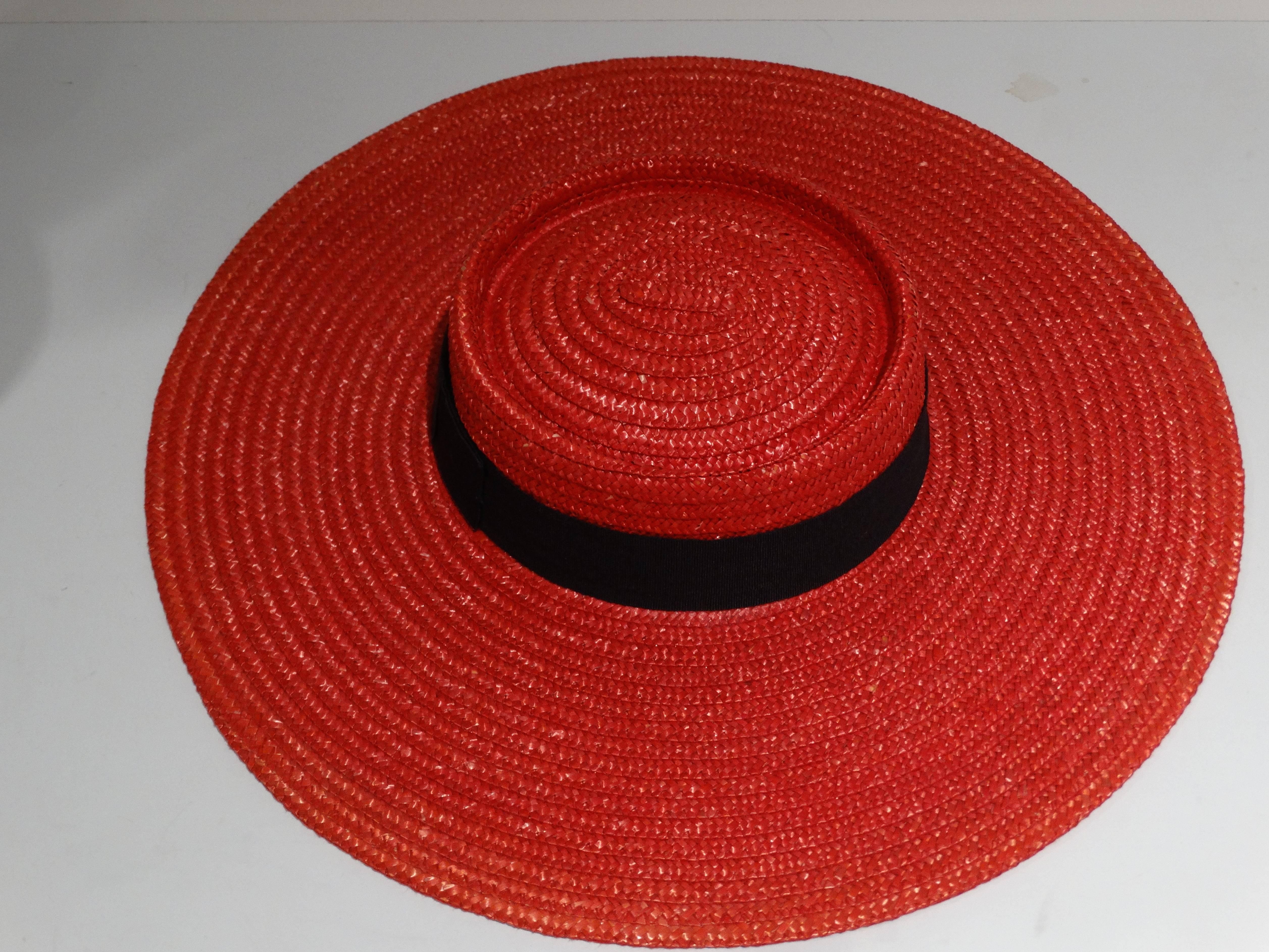 A true one of kind piece, created in the 80's! This limited edition a wide brim red Gucci straw hat with a black ribbon bow with the gold GG logo is sure to turn heads! The bow is to be worn in the back, hat look best tilted to one side.