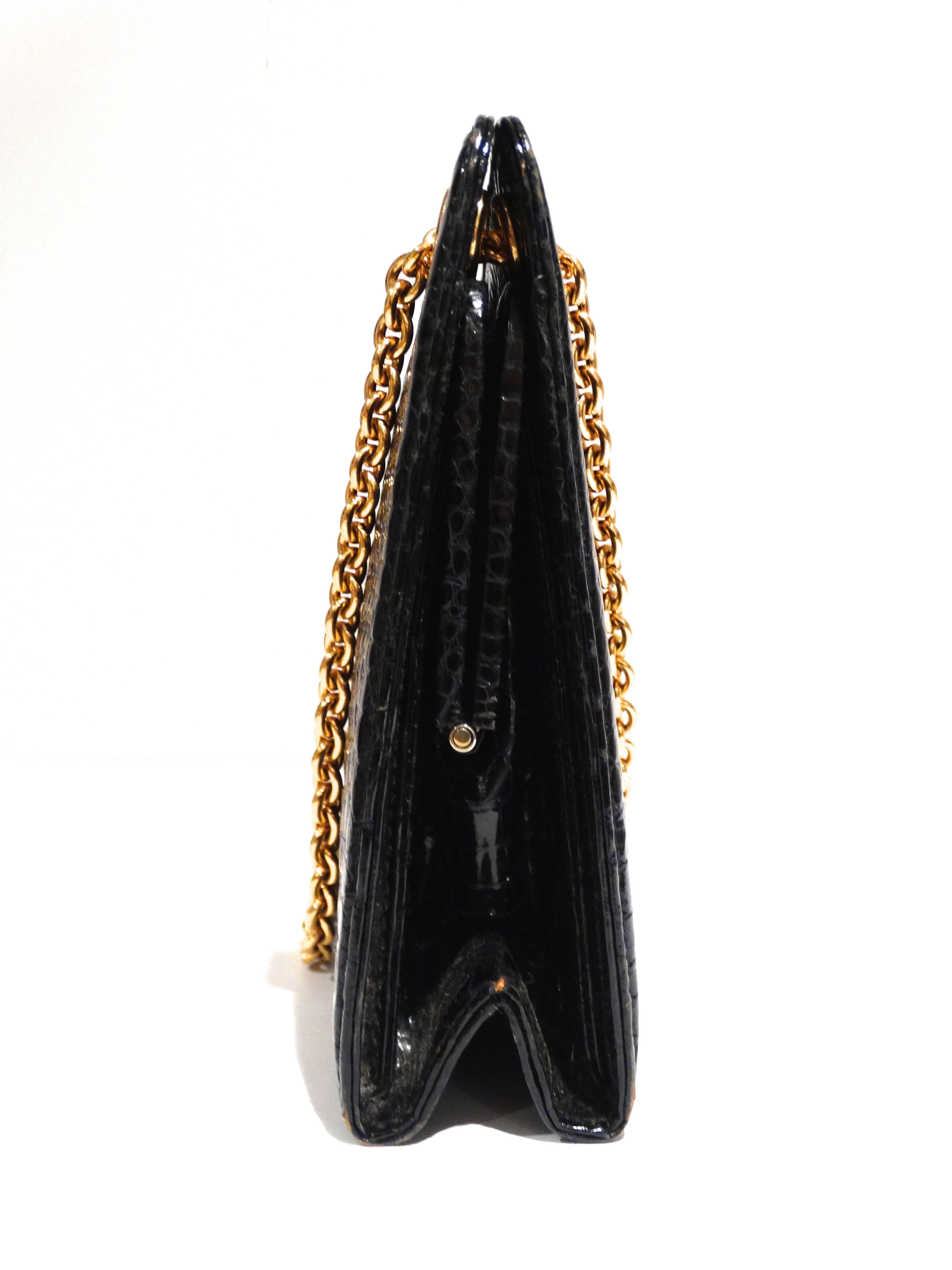 This is a rare vintage black crocodile skin handbag by Gucci, from the 1950's. It has a double chain handle which is 7