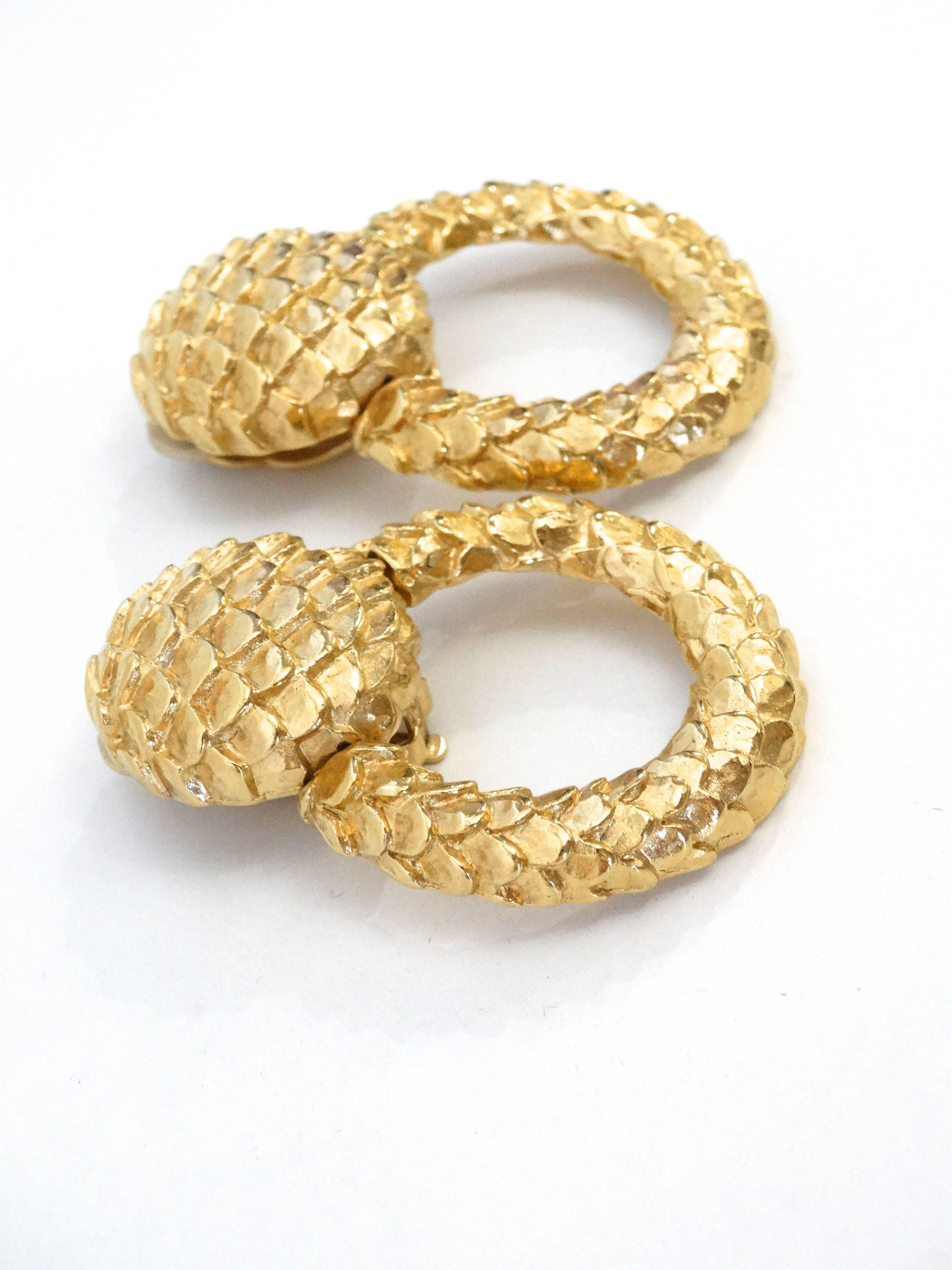 Statement hoops by Givenchy circa 1980s with a magnified snakeskin texture. Plated in gold, these hoops are sure to get noticed! 

Measurement 

3