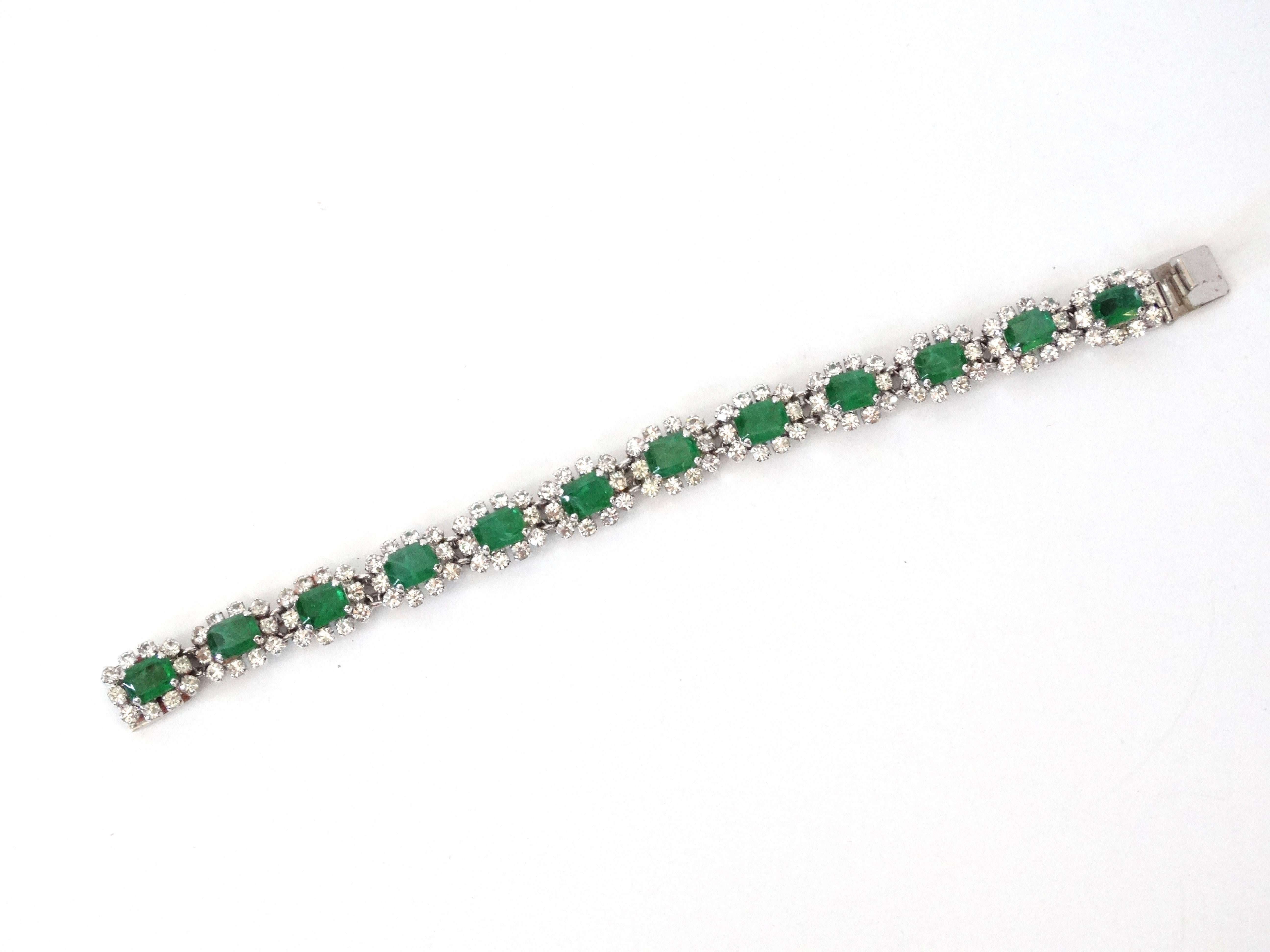 A beautiful link bracelet designed for Christian Dior by Henkel and Grosse Diamante and Emerald Link Bracelet features 12 settings of diamanté and glass emeralds signed  Chr Dior, C, Germany, 1969 Reference: Mark dates this to 1969, and identifies