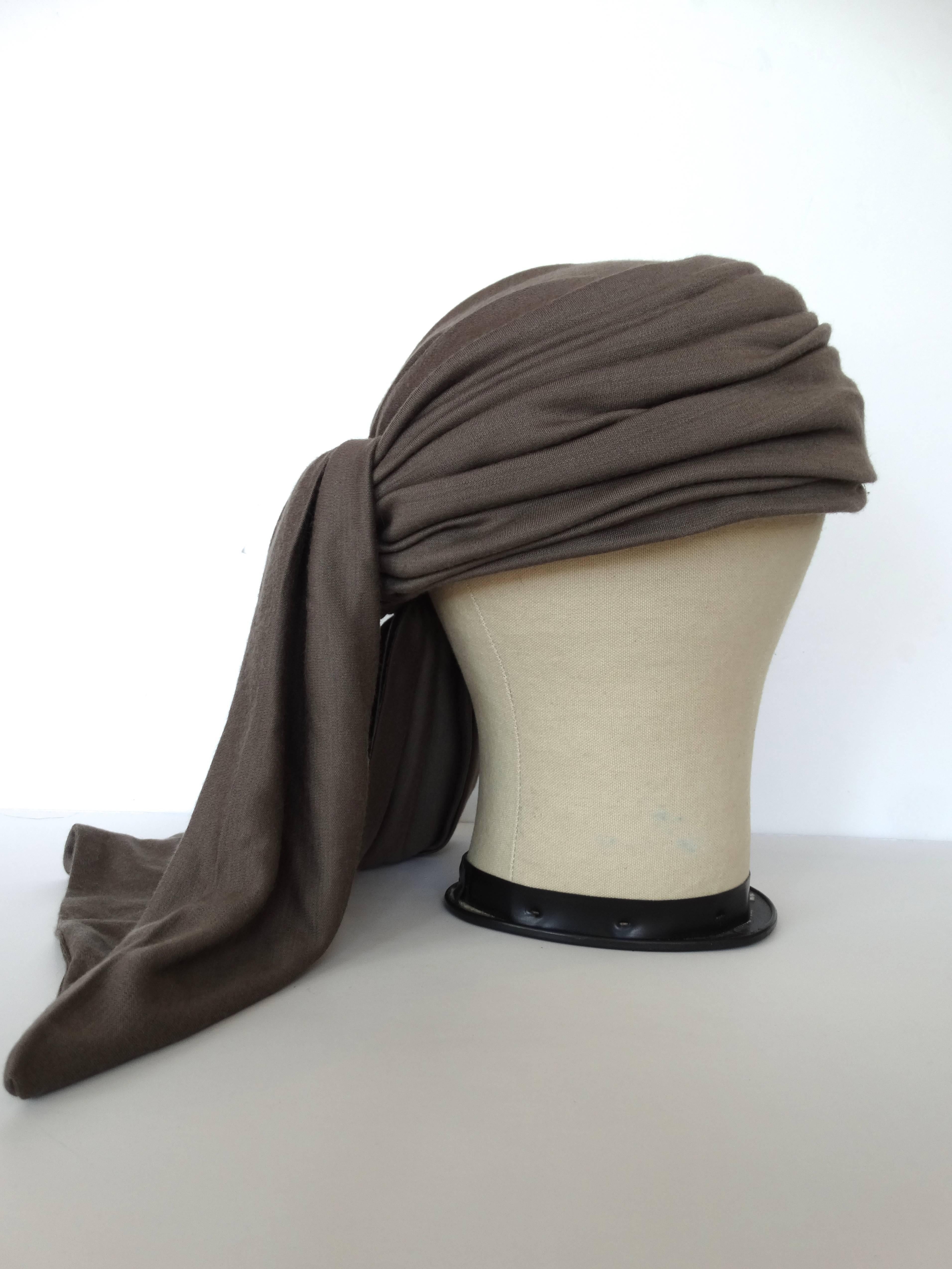 This iconic Rive Gauche YSL Turban is a true Yves Saint Laurent collectors dream piece. Numbered #453 in a very pretty shade of Taupe. Measures approx. 21