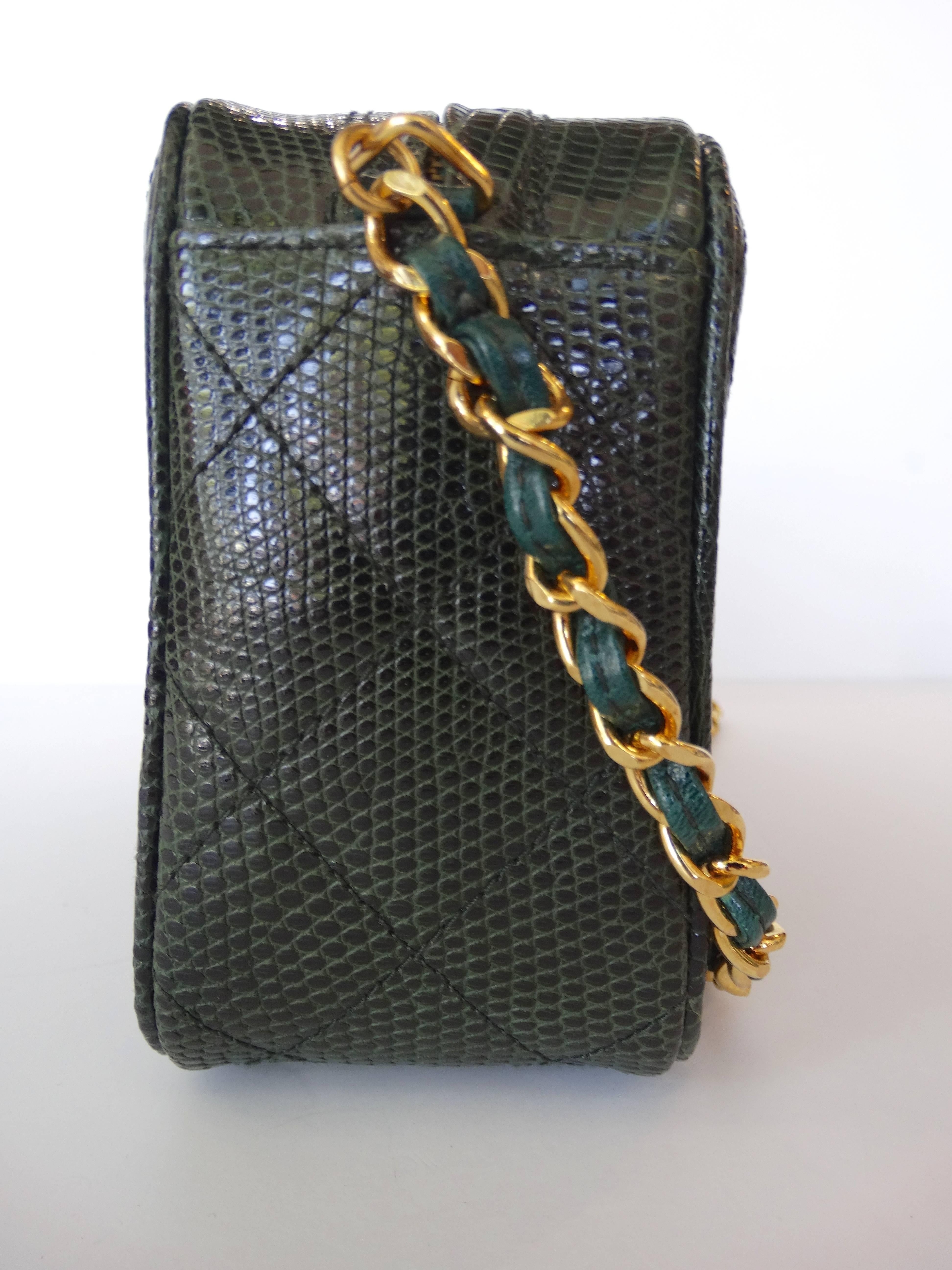 Early 90's green quilted lizard Chanel vintage camera bag with gold-tone hardware, single chain-link shoulder strap,  black leather lining, single zip pocket at interior wall and zip closure at top with tassel charm pull. Serial number reads