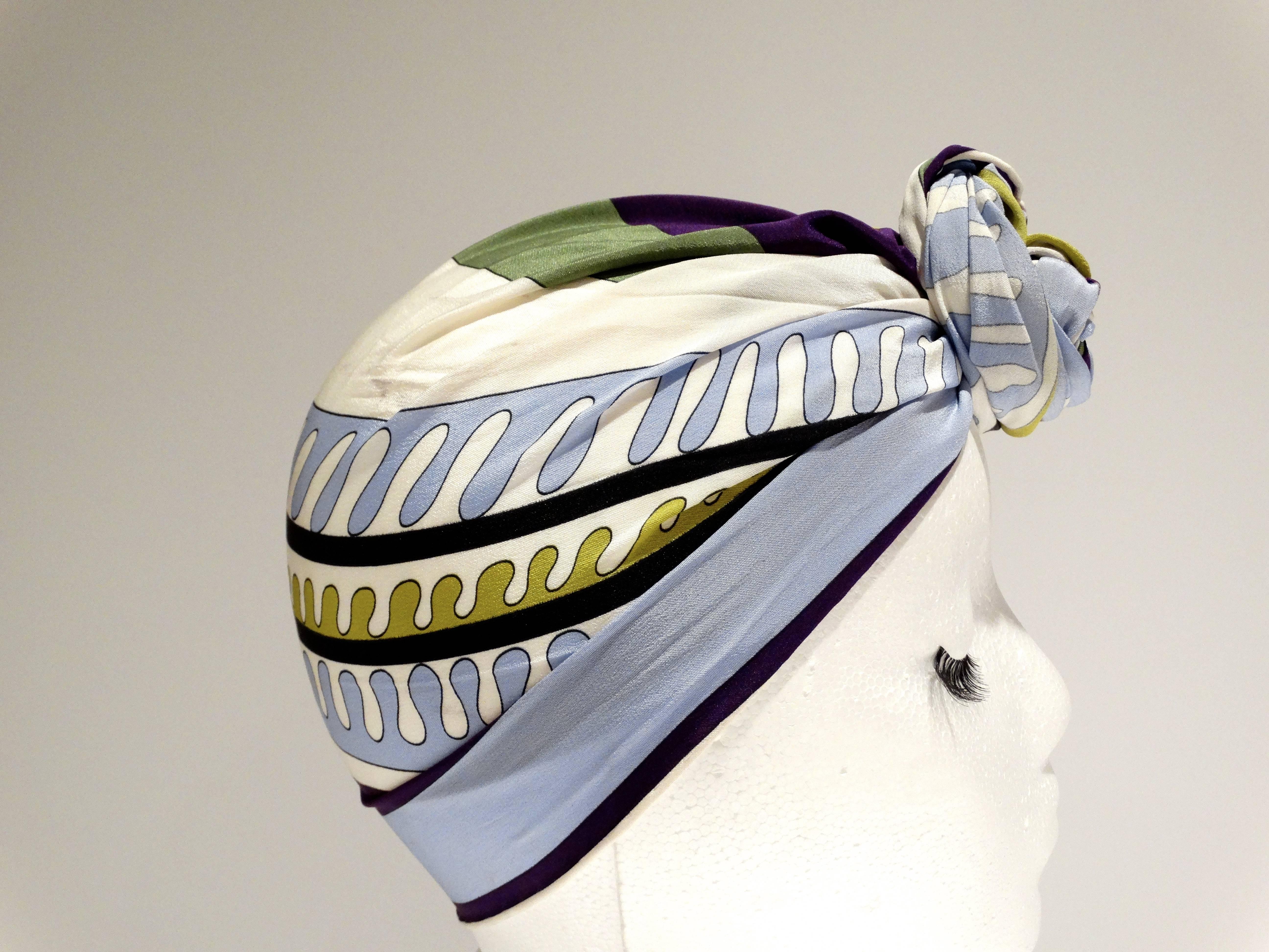 1990's Emilio Pucci rectangular silk scarf in a bold geometric print. Colors are white, black, sky blue, greens and deep purple. Hand rolled and hand stitched edges. Measures 48 x 8.6 inches great for wrapping (shown in images) signed Emilio through