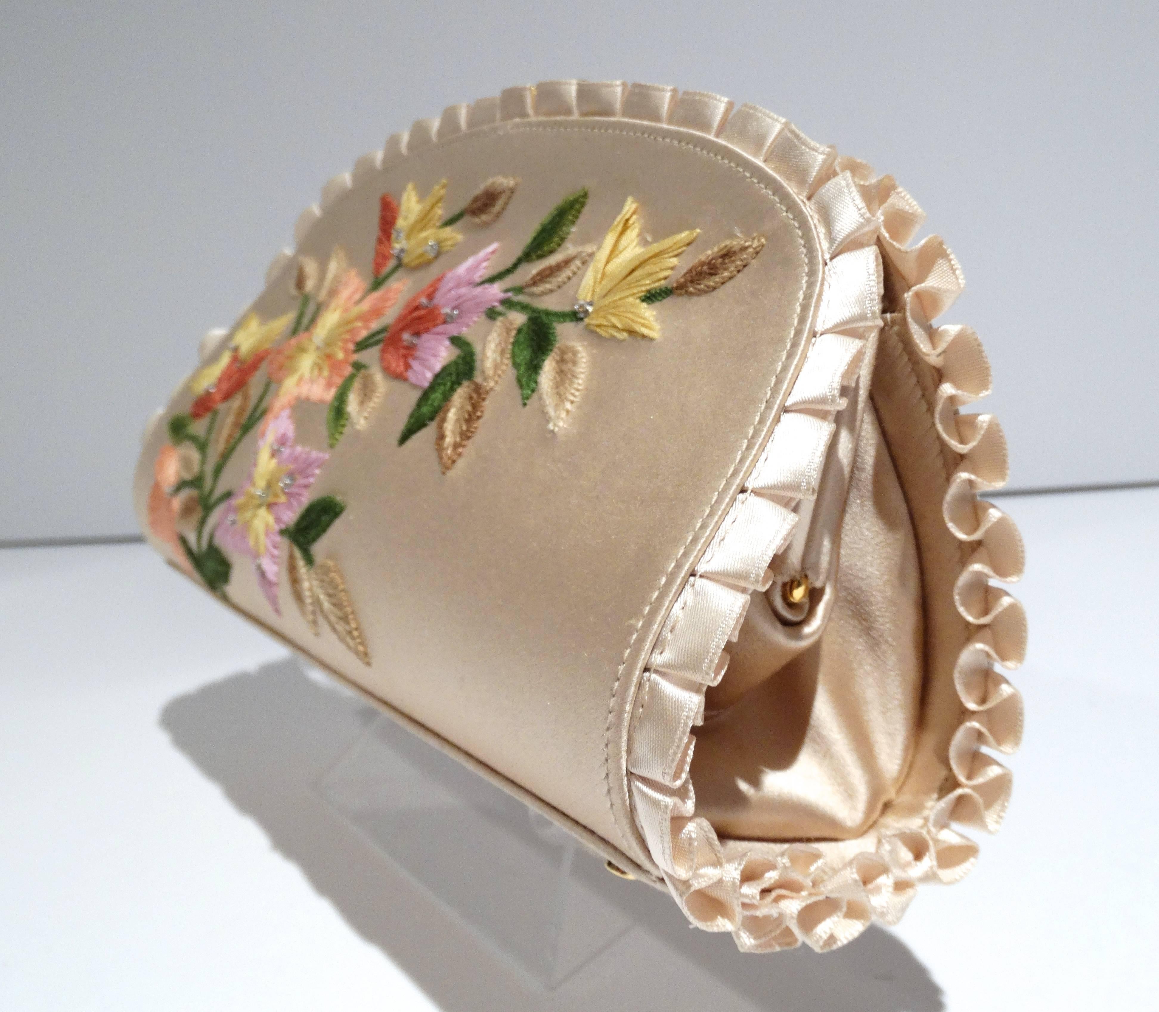 Exquisite Bohemian Judith Leiber original design clutch new with tags. This beautiful clutch features a wonderful floral embroidered detail. The superb champagne color silk is accented with a perfect knife ruffle pleat along the edges. The purse