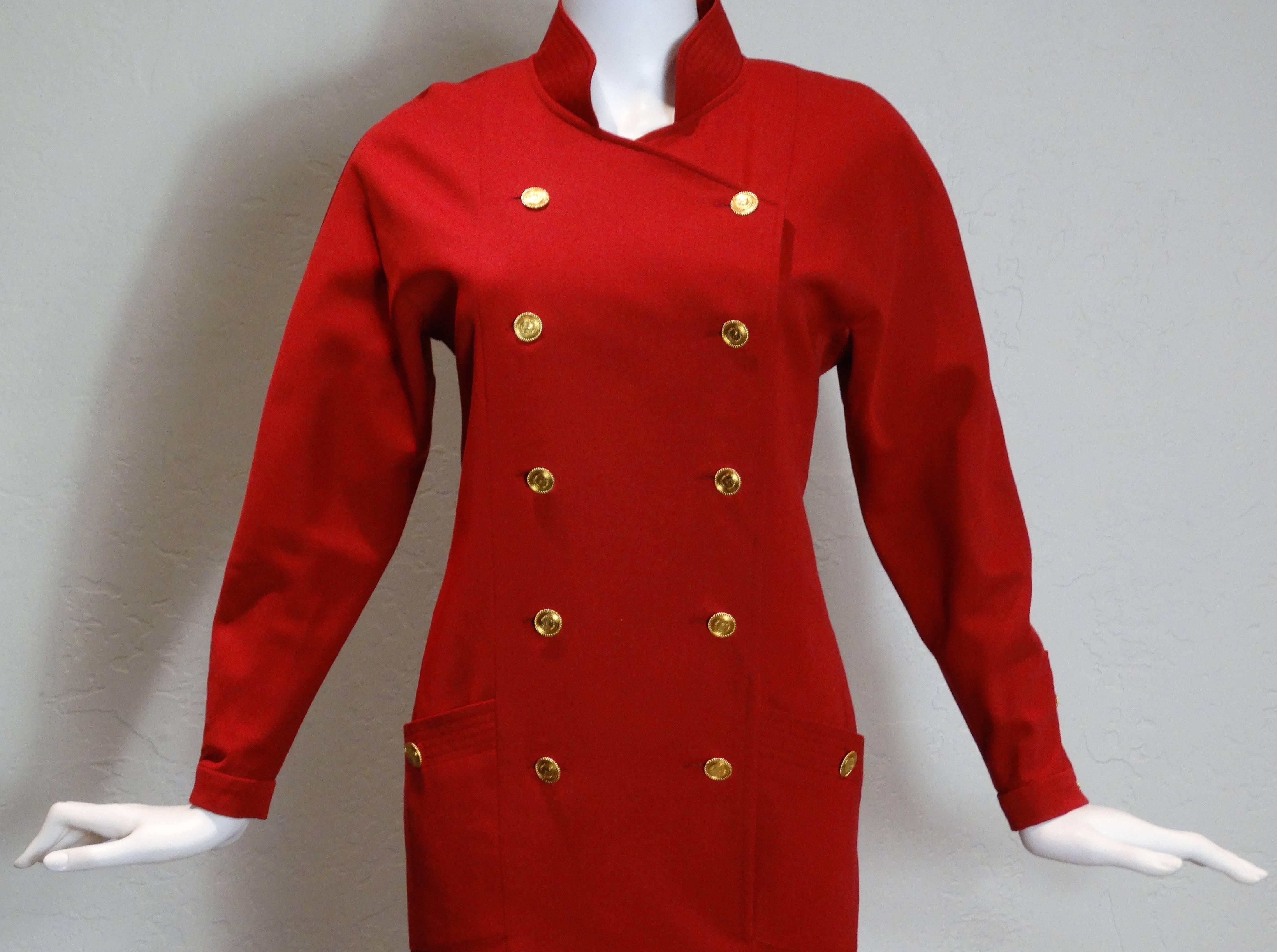 A true classic created by Chanel in the late 1980's. The little red dress has a button front with 10 Coco Chanel Buttons and 2 Coco buttons attached to the side pockets. This dress has a high collar and structured shoulders. Long-sleeves  with three