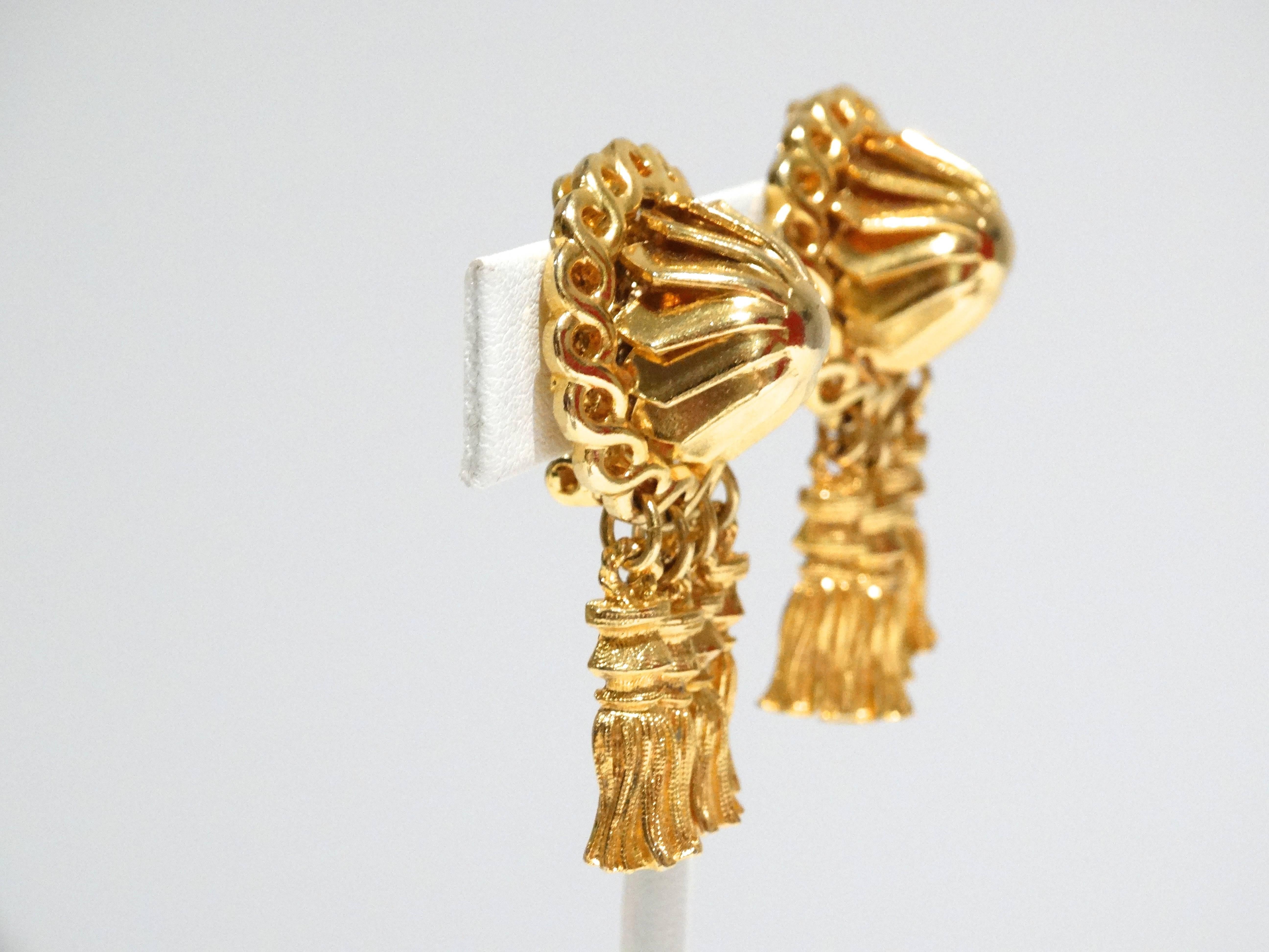 1970's item by William de Lillo. This is a beautiful pair of studded clip tassel earrings all in gold gilt with a heavy linked gold-tone chain edge. Perfect to wear as your everyday earring. The gold is a vibrant in color.  The earrings are 2.5