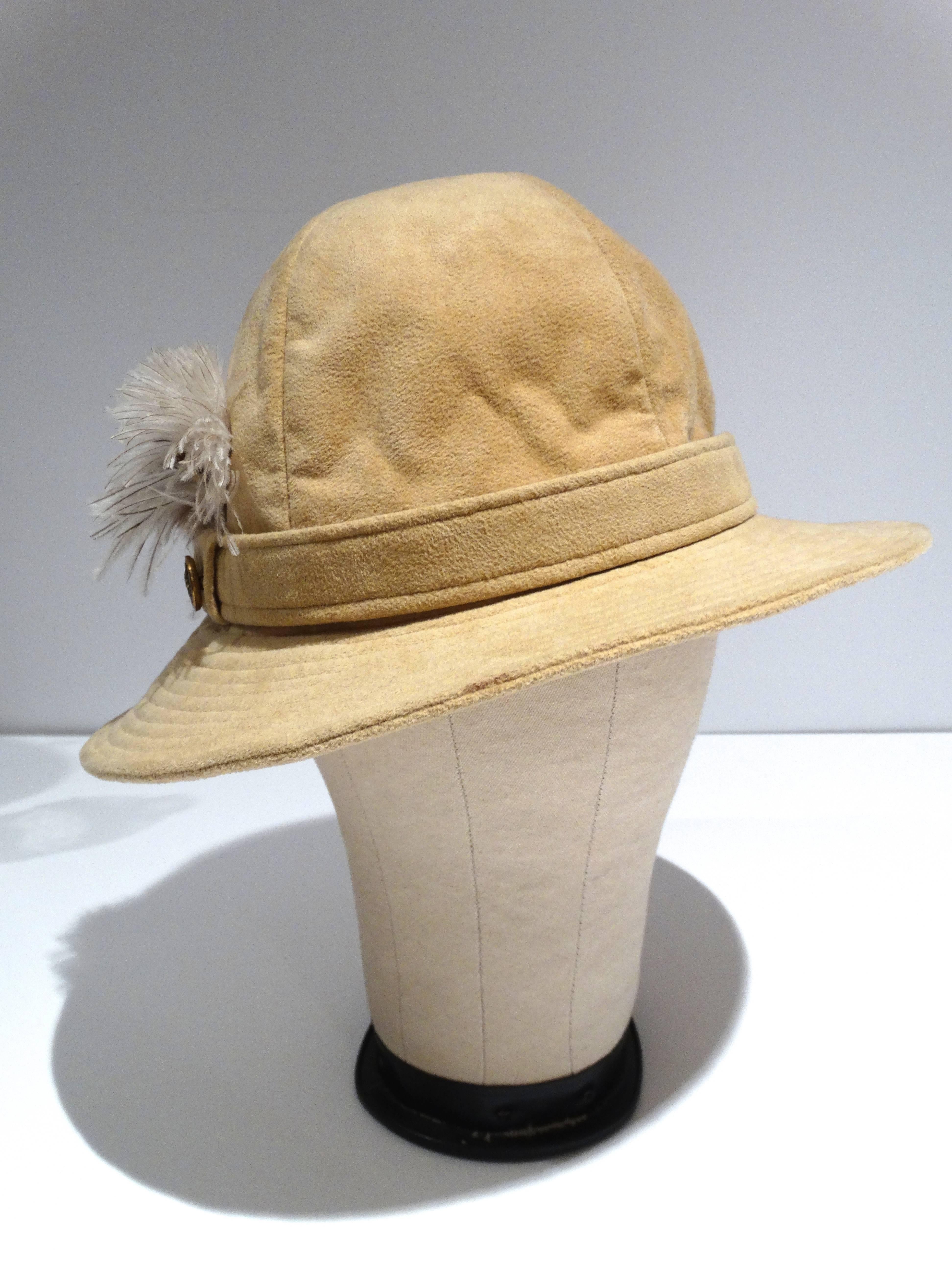 This vintage 1970's Adolfo Realites for Neiman Marcus is absolutely stunning. It does have an air of bohemian glam. Something that Bridgitte Bardot would wear. The hat features a cluster of pheasant and ostrich feathers. In a light beige suede with