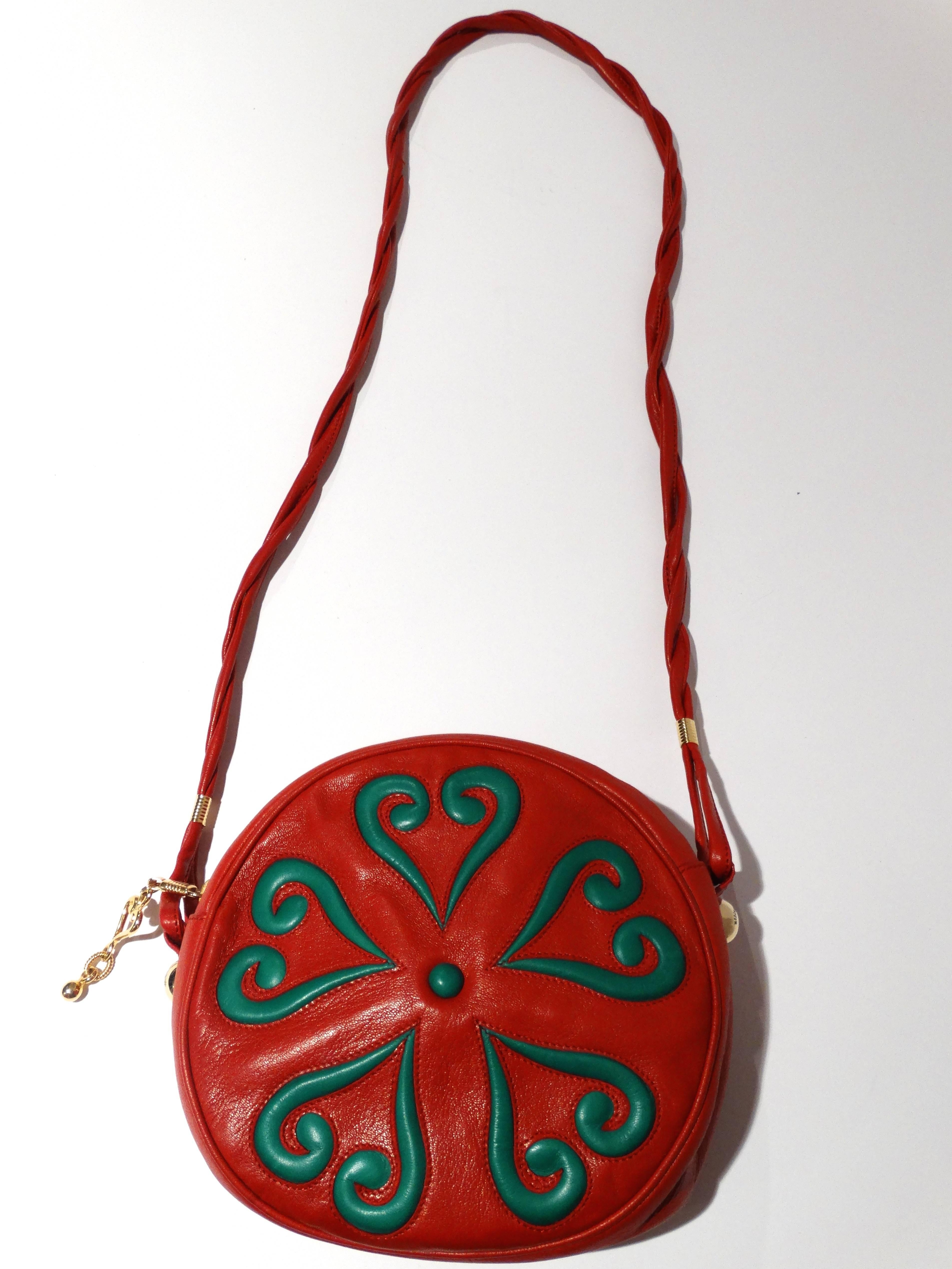 Heart of Hearts.. early 1990's Moschino by Redwall shoulder bag. In lipstick red! Great heart design on the front in kelly green leather. circle shape with a twisted shoulder strap. Great gold hardware with a large gold heart pull on the zipper.