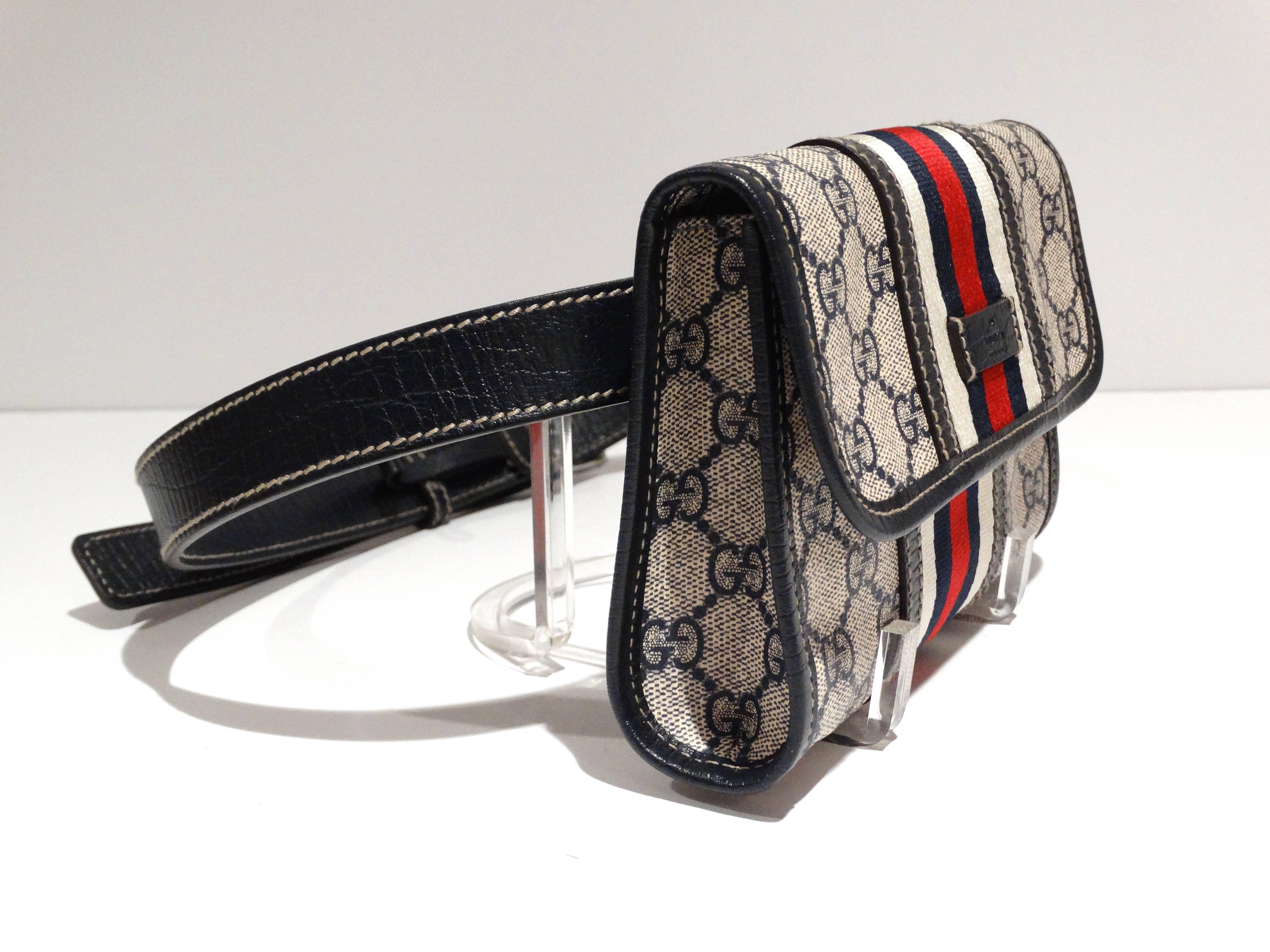Rare 1980s classic Gucci fanny-waist pack with leather belt. This super chic fanny pack bag is crafted of coated Gucci GG blue on white monogram coated canvas with navy blue leather trim and a long adjustable waist belt strap with silver hardware.