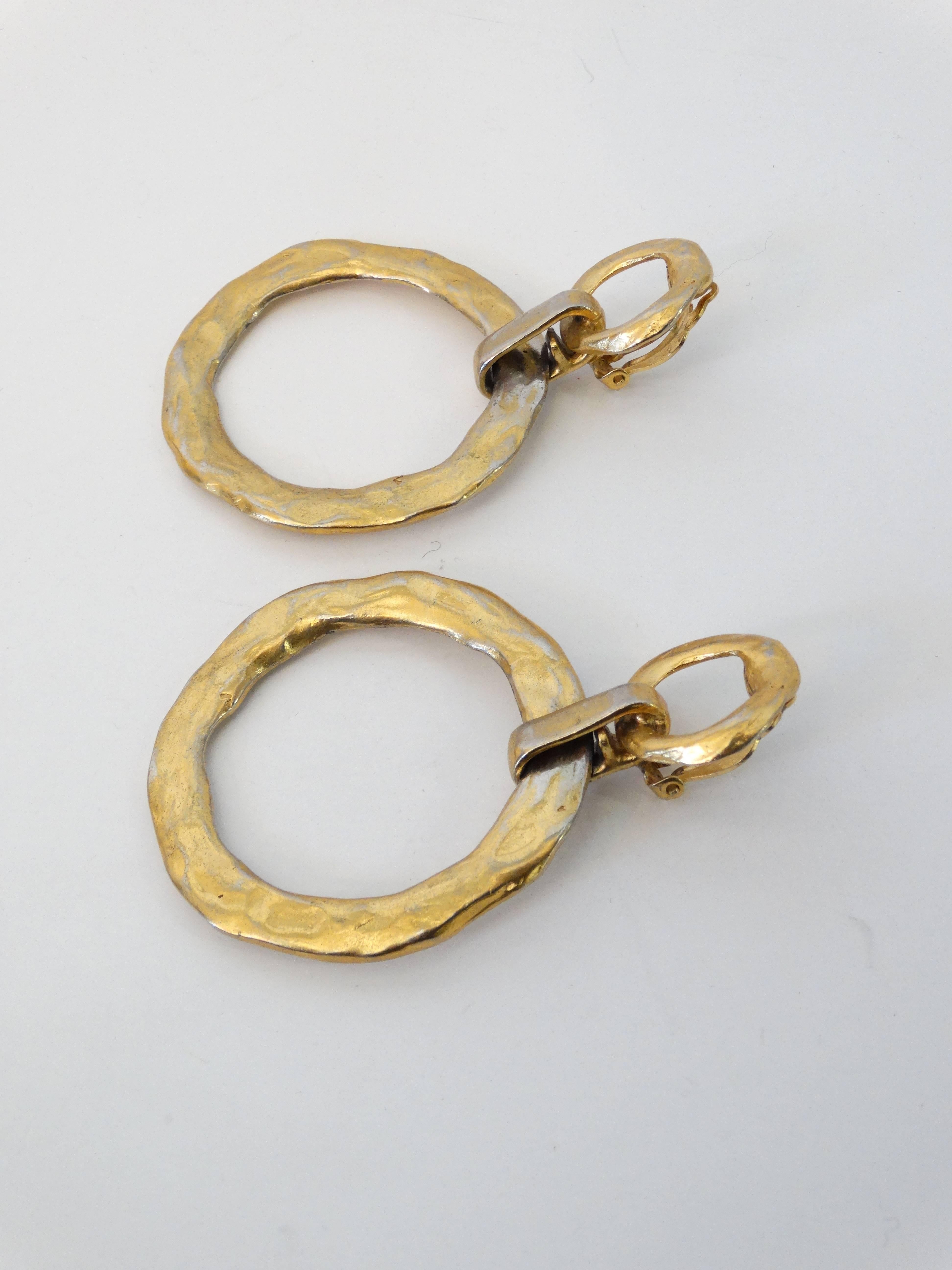 Rare... Lovely 1970's YSL Gold plated hoop clip earrings styled with a hammered look. Large in scale signed YSL Made in France gold plate is faded in some areas. 

3 1/2 inches long  by 2 1/2 inches wide