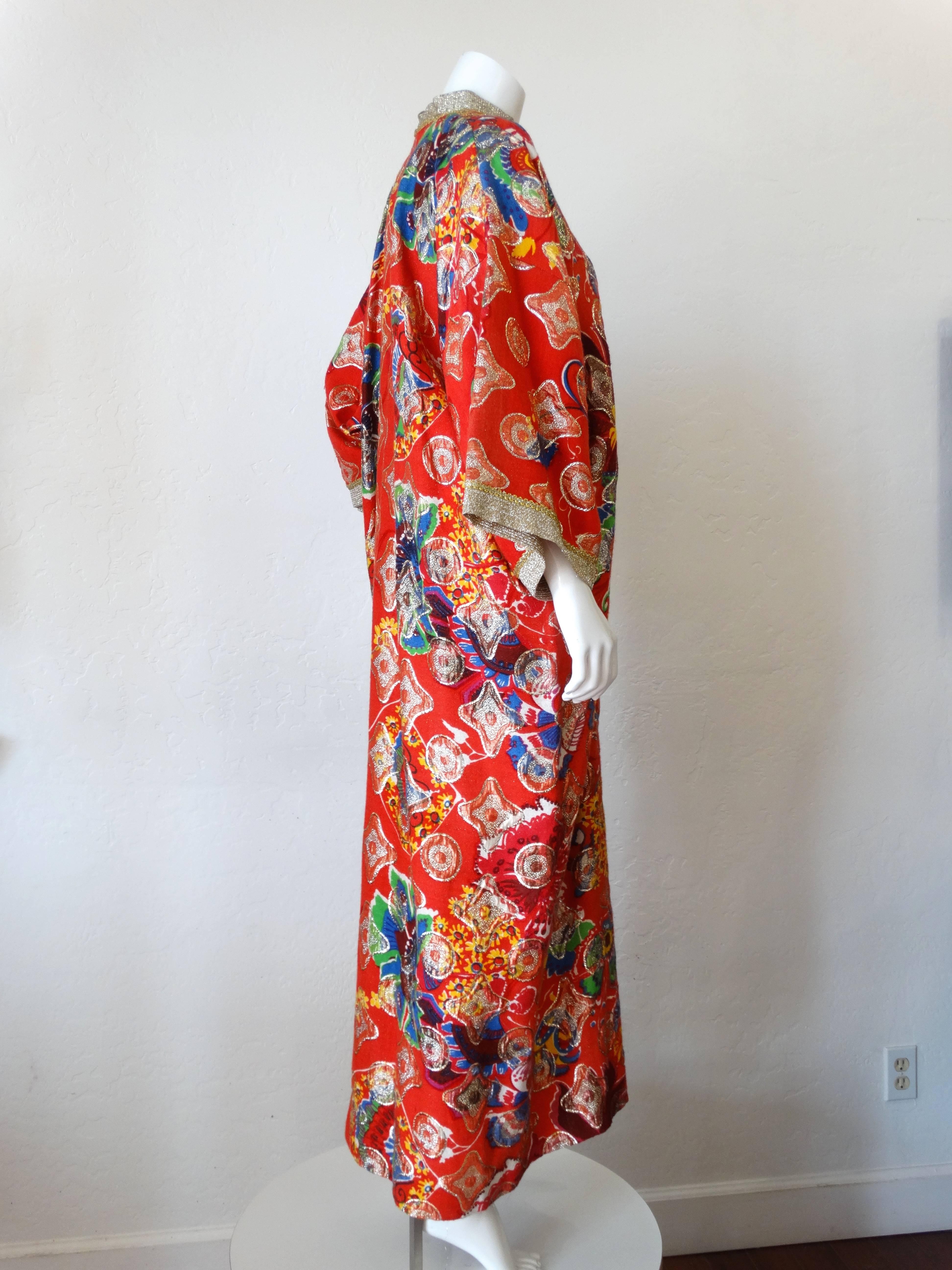 This is an extraordinary and incredibly unique vintage 70s iconic designer
 ‘JAY MORLEY for FERN VIOLETTE Neiman Marcus’ stunning red rich art metallic caftan dress featuring front gold lame' knit buttons. Wide Sleeves with a thick gold lame' trim.