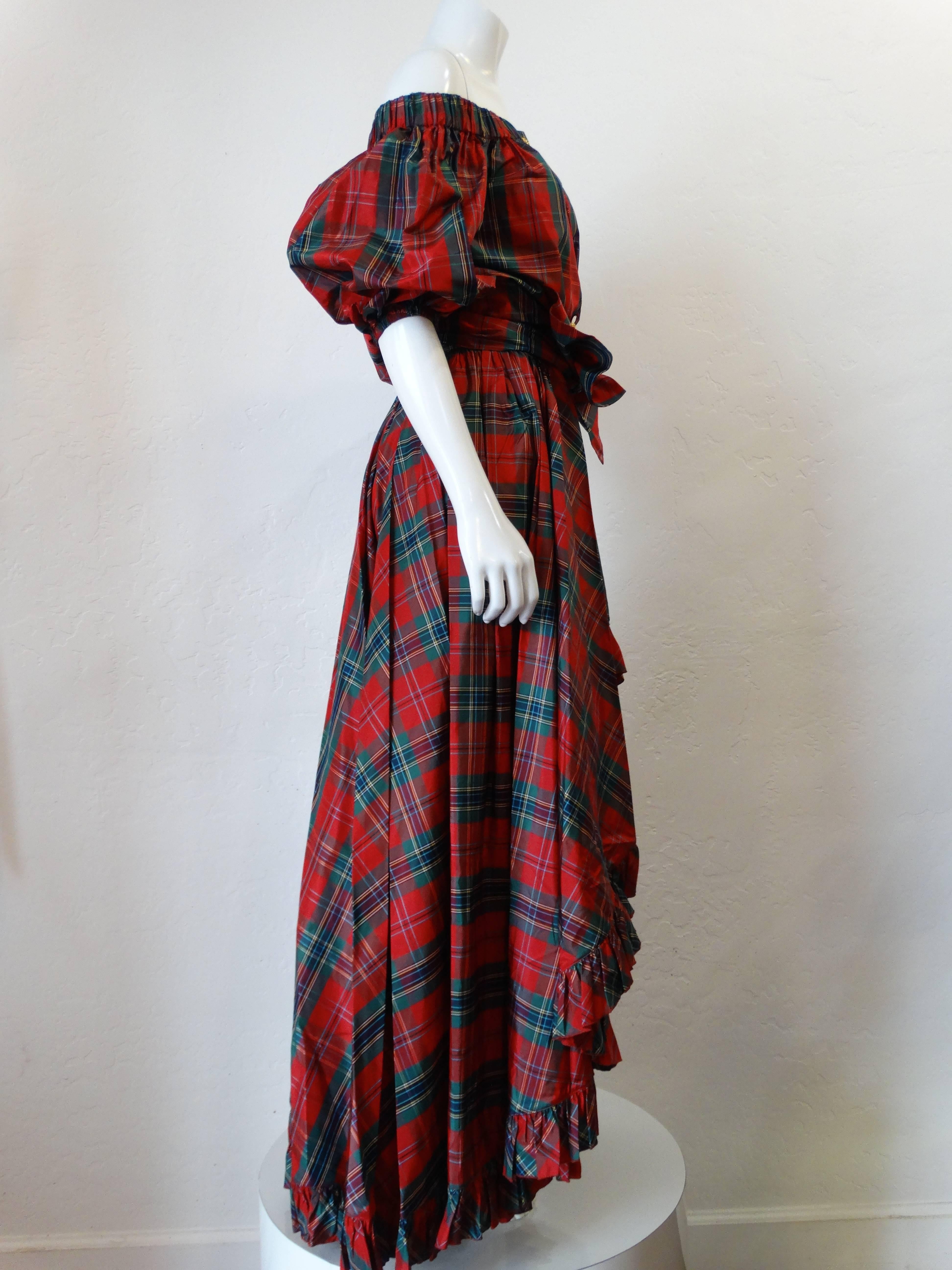 Rare late 1970's Saint Laurent Rive Gauche tartan plaid silk blouse and skirt. Blouse features 3 large gold buttons and is off the shoulders. Skirt is high-waisted with a thick ruffled hem , short to long hem.Long sash belt attached. 
Size EU skirt
