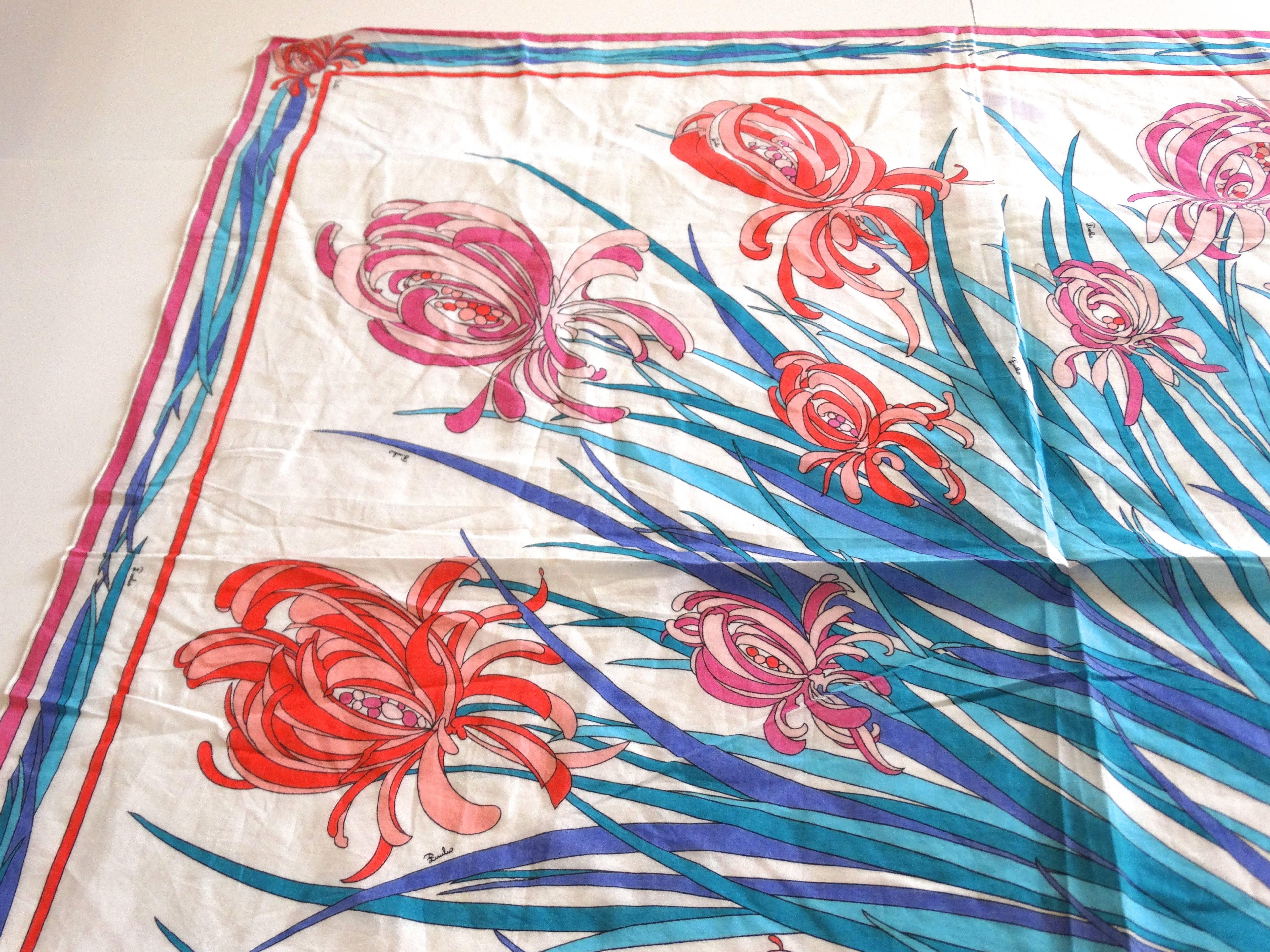 Taken it back to 1973 ...What a great example of the amazing prints Emilio Pucci was so famous for. Orange,pinks and peach iris flowers on top of a spray of blue stems. Abstract, and whimsical, this signature Pucci print is very recognizable and