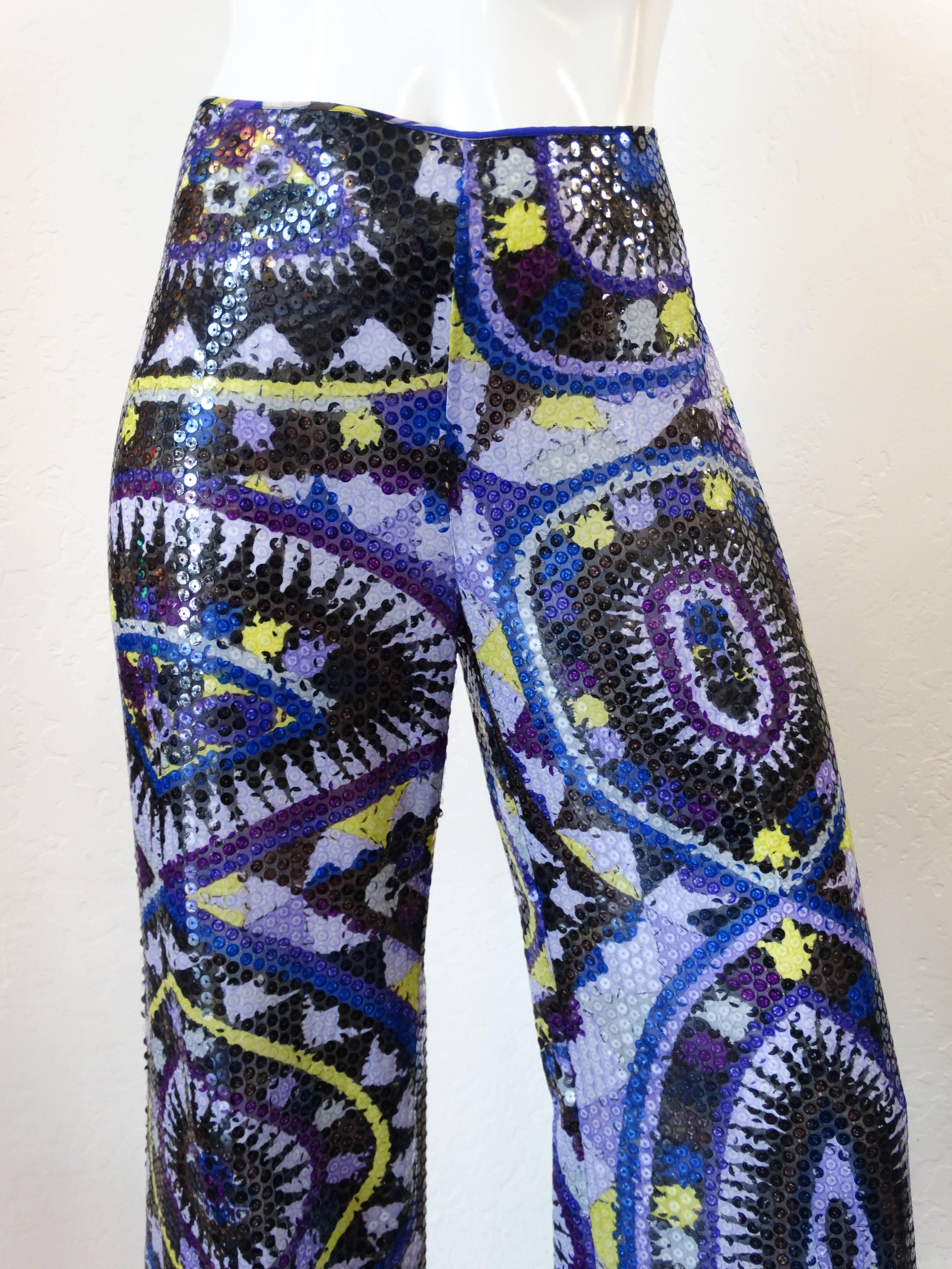 Simply stunning late 1990's Emilio Pucci sequins pants with a kaleidoscope print. The pants are flat fronted and zip to close at the side with a painted metal zipper. Covered in clear flat sequins, these pants are also a wide leg. No flaws and looks