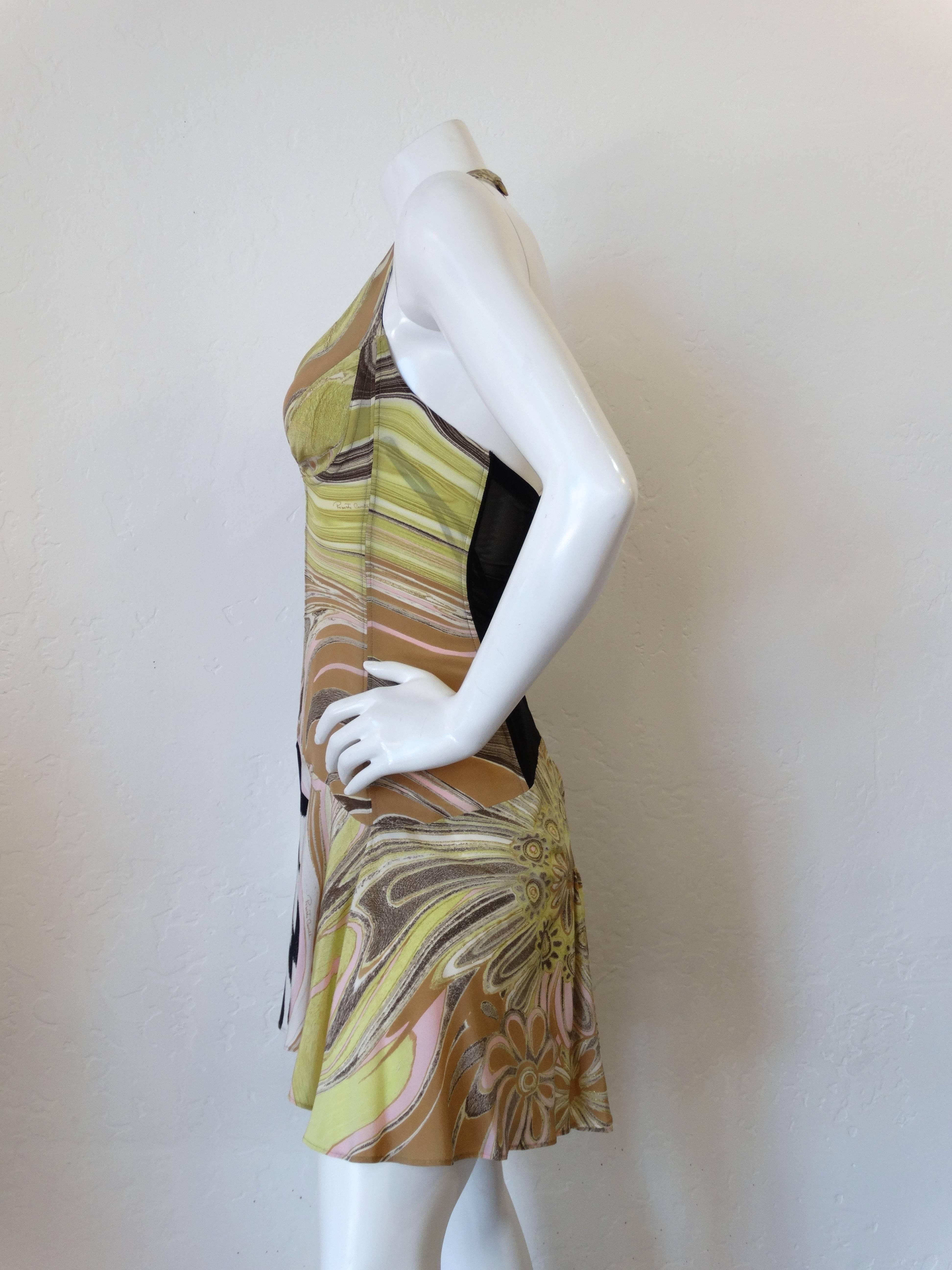 This NWT Roberto Cavalli dress is in brand new condition. This incredible dress boasts a sexy woven cut out below the bust with a boning reinforced bodice. Halter strap fastens at the back of the neck- hook and eye closures up the mesh panel in the