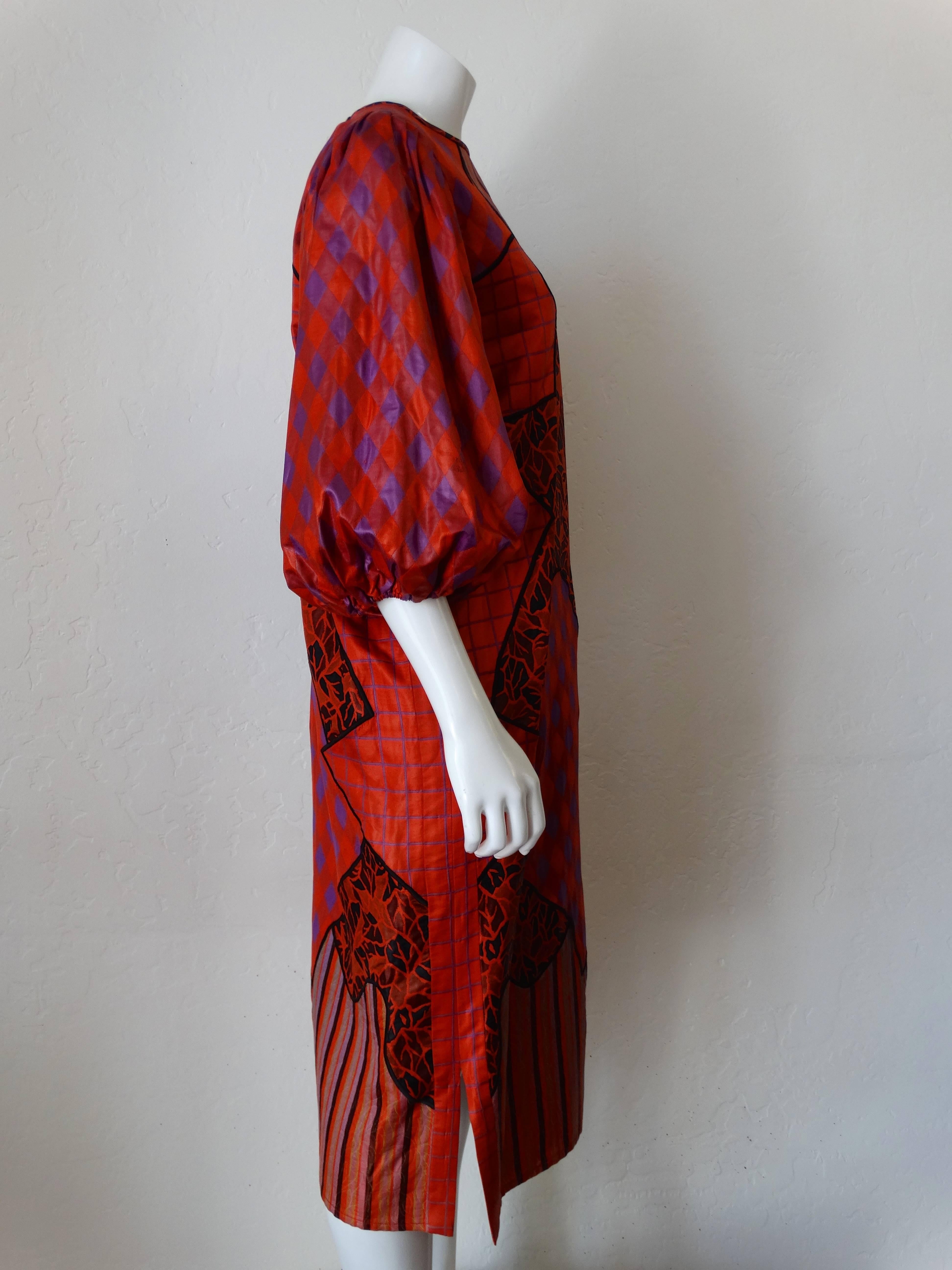 Avant Garde 1980s Diane Freis runway patchwork dress! Billowing balloon sleeves in bold red and violet gingham print. Patches of stripes, leaf-like print and grid. Dress pulls over the head with keyhole closure at the back of the neckline. Made in