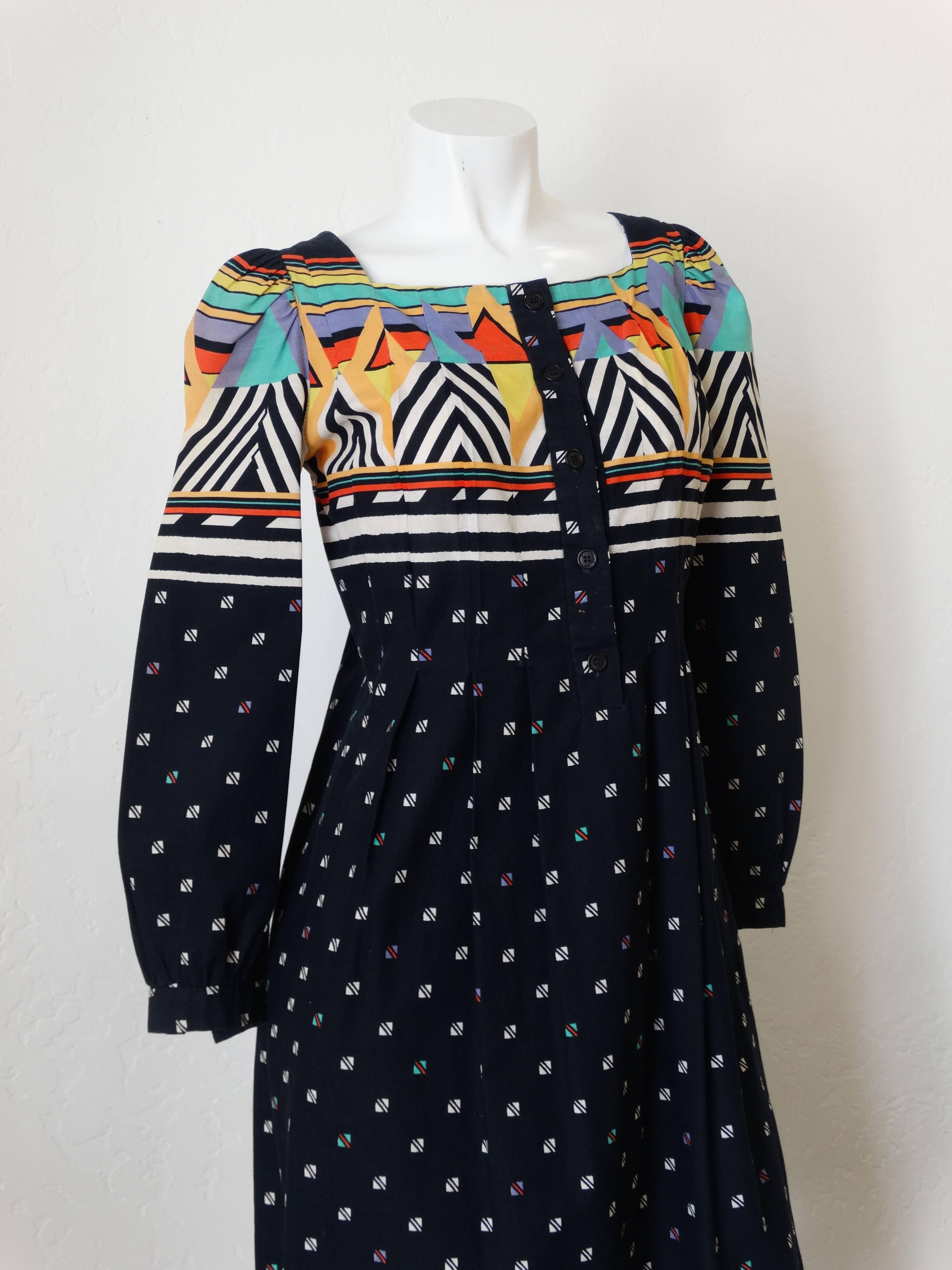 Beautiful 1980's “California Girl” Geometric Print Dress. Black and white triangle print. Pin-tuck style stitching at the bust. Button up bodice. Contrasting blocked prints with multicolored stripes and chevrons. Vibrant colors, dress is cotton.