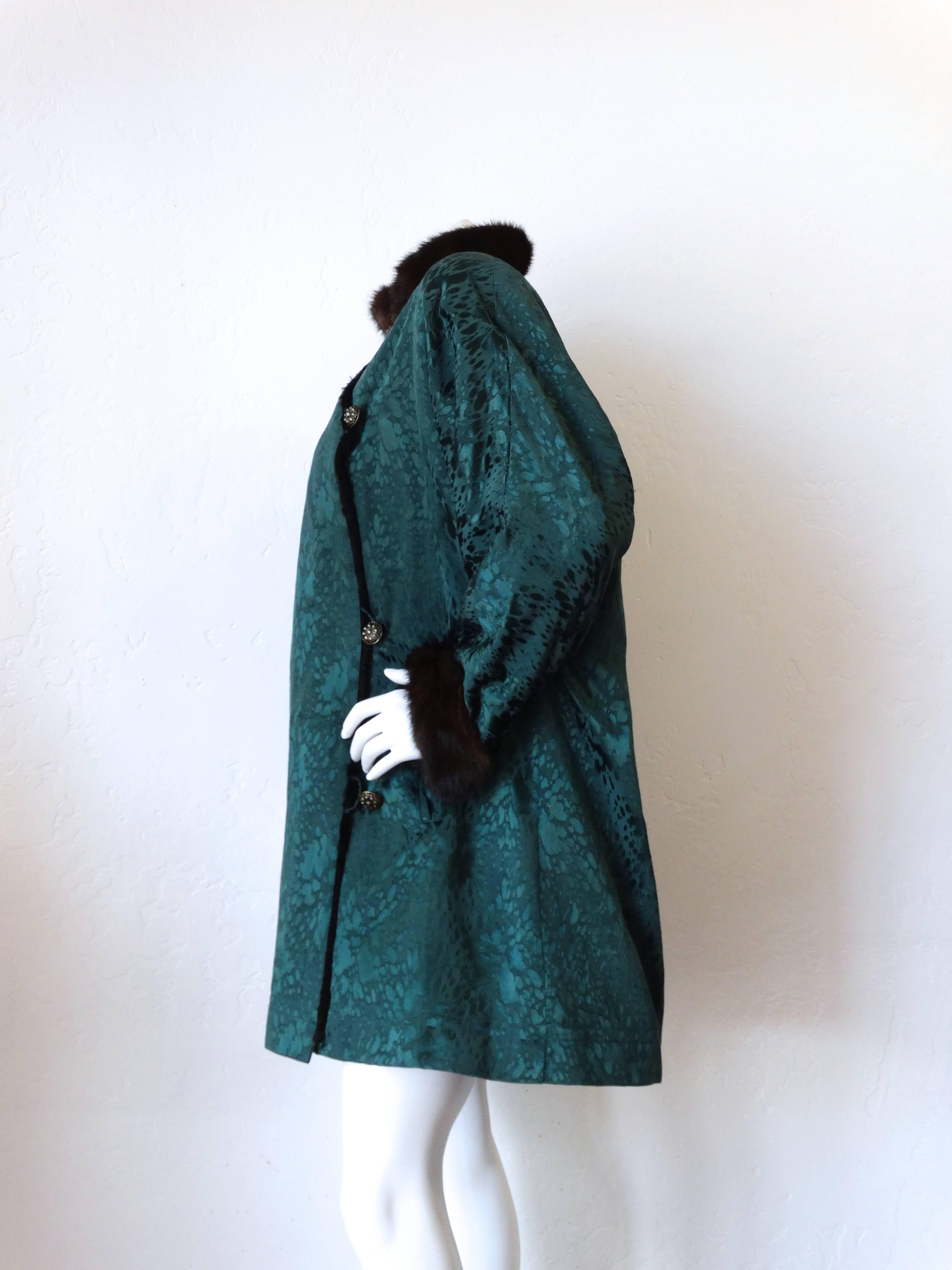 Chic 1980s Yves Saint Laurent Fur Lined Coat. Forest green silk fabric. Sheared mink interior. Mink cuffs and collar. Single breasted button closures up the front. Pockets at either side of the waist. Fits a todays size 6 or 8 