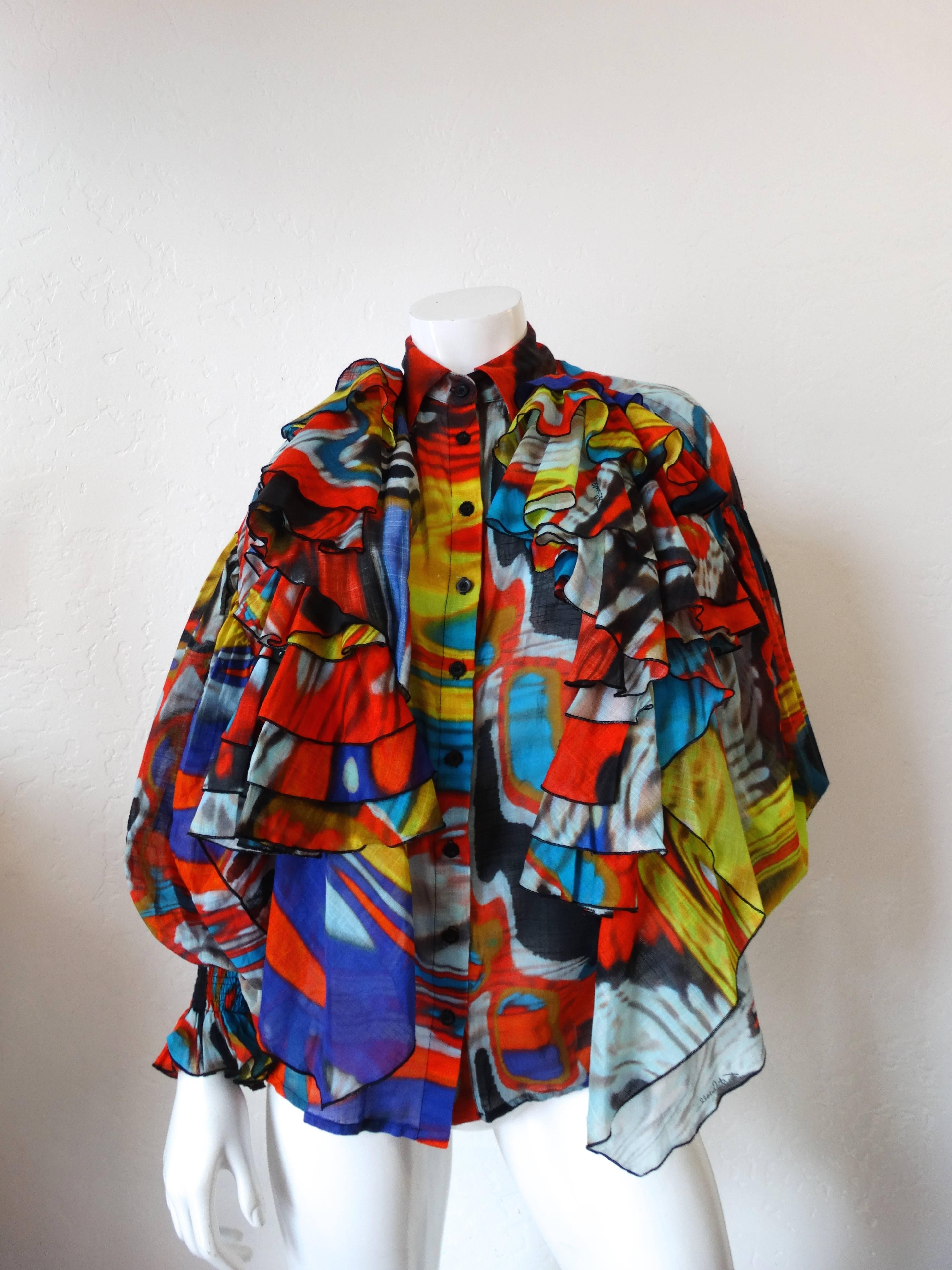Avant Garde Just Cavalli Camicia Ruffle Top. Buttons up the front. Dramatic flared sleeves with cinched, elasticized cuffs. With ruffle detail at both shoulders. Psychedelic multicolored marble print. New with tags, never been worn.
Marked a size