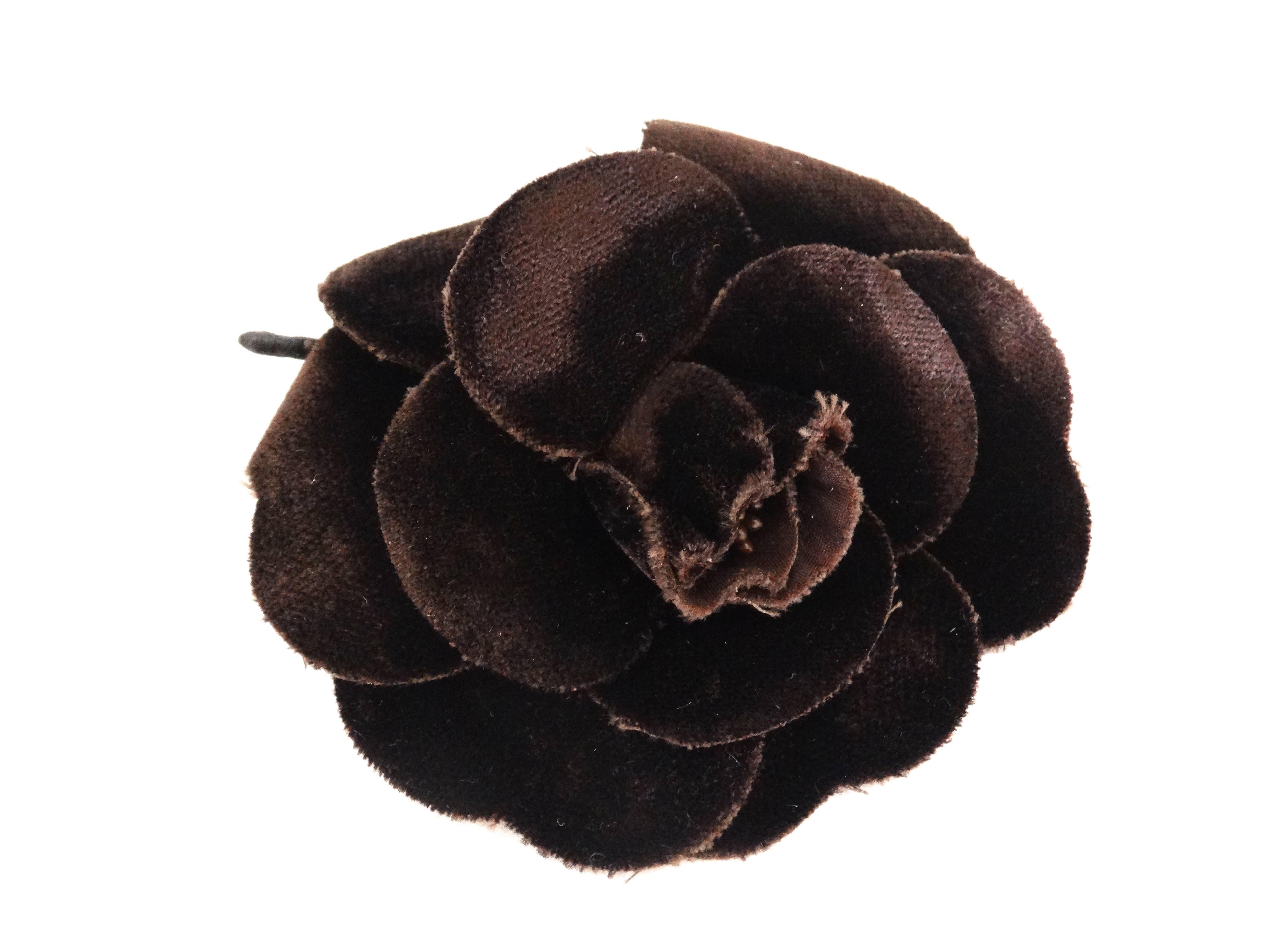 This classic 1980's Camellia Chanel brooch is made of chocolate velveteen, petals have a raw edge cut. Pin closure at back, Chanel signature plate attached. 

Measurements: 
3.5 inches by 3.5 inches in diameter 