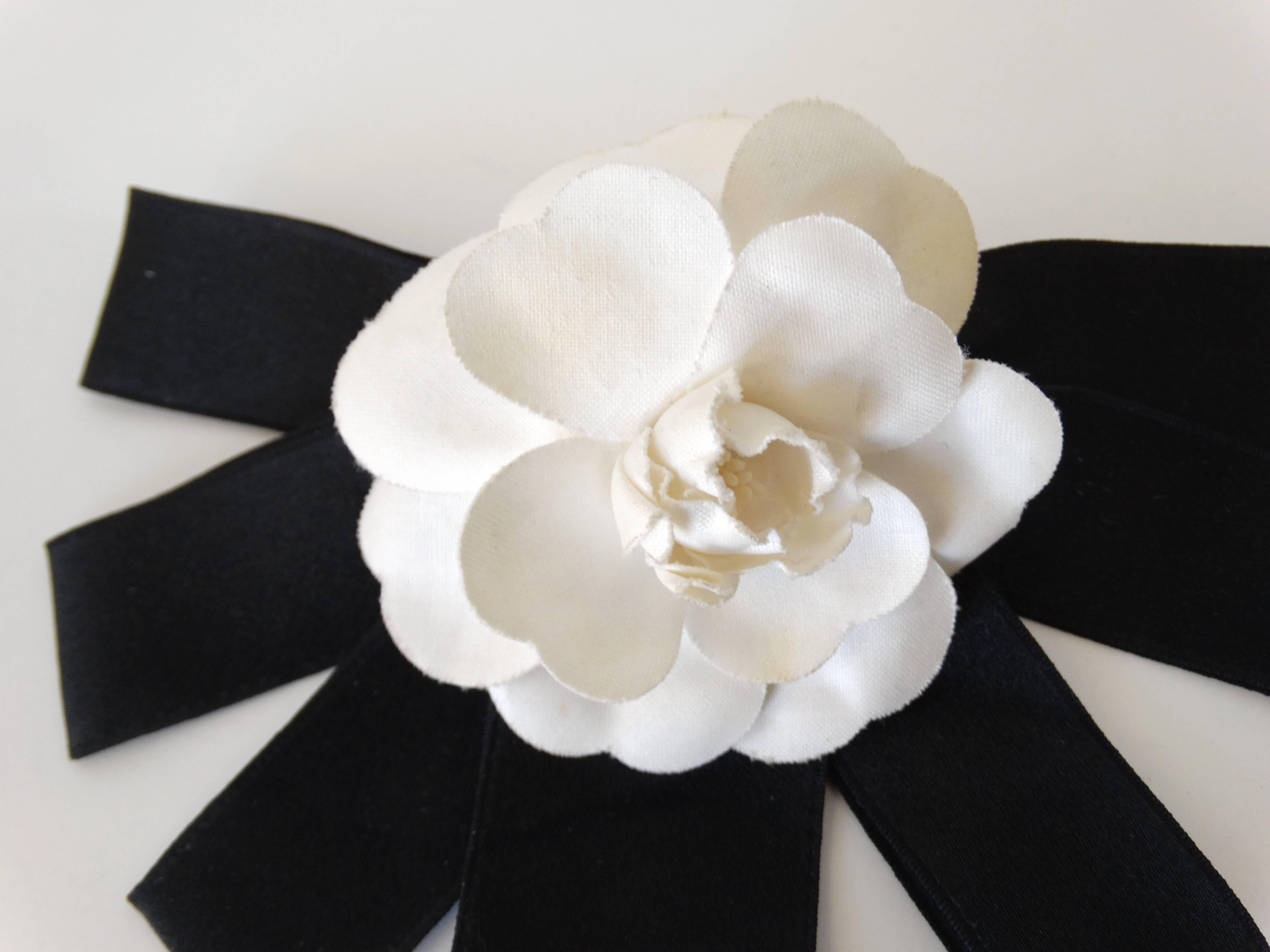 1980's rare large Chanel Camellia flower hair barrette with 7 pieces of ribed ribbon which form a half circle. 9 inches across Chanel signature plate attached on the back. Dates to the 1980s 