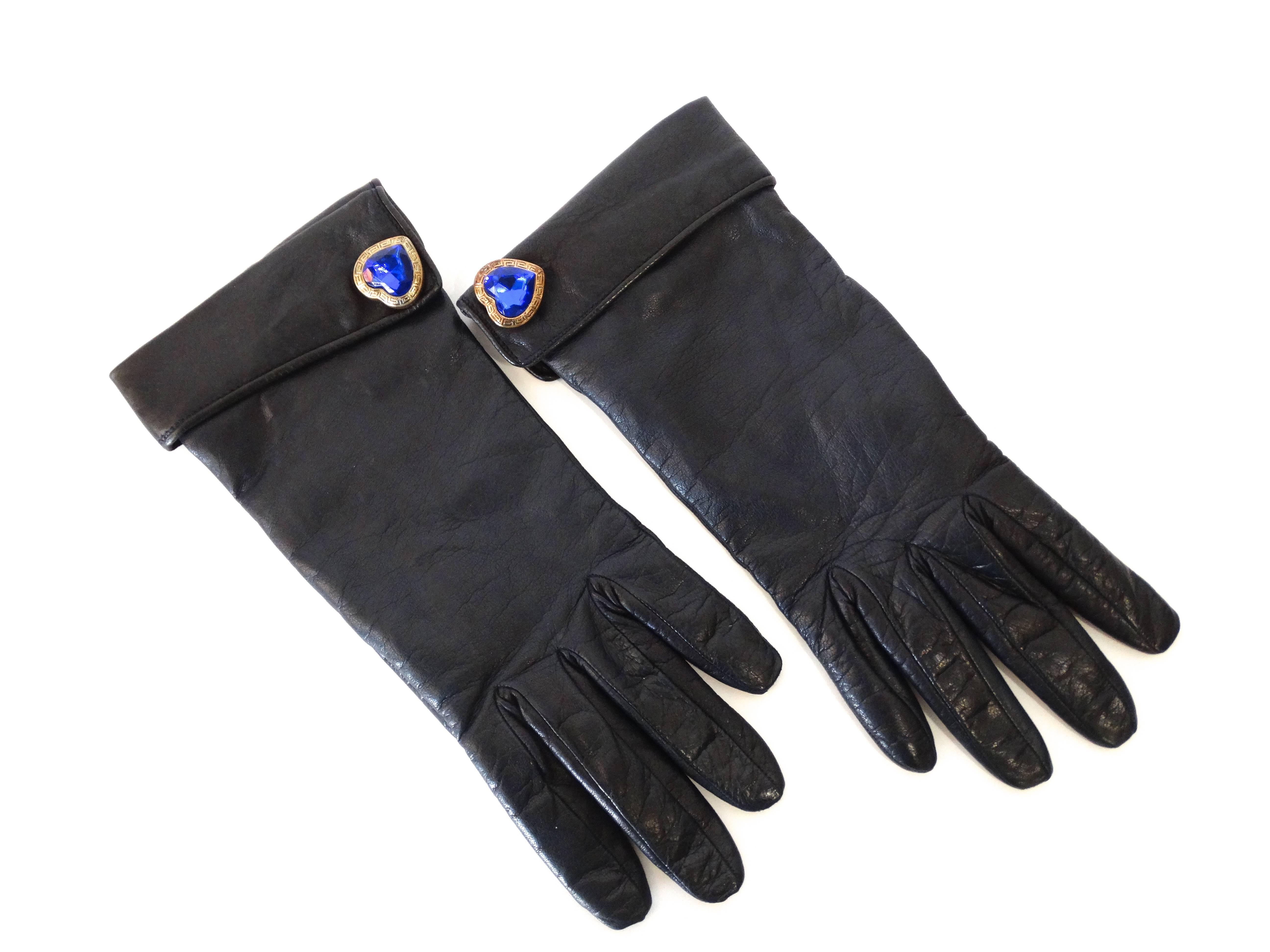1990s Navy Leather Moschino Gloves. Fully lined with tan knit wool. Blue jewel heart buttons on the cuffs. Marked a size 7 label inside the glove Made in Italy 