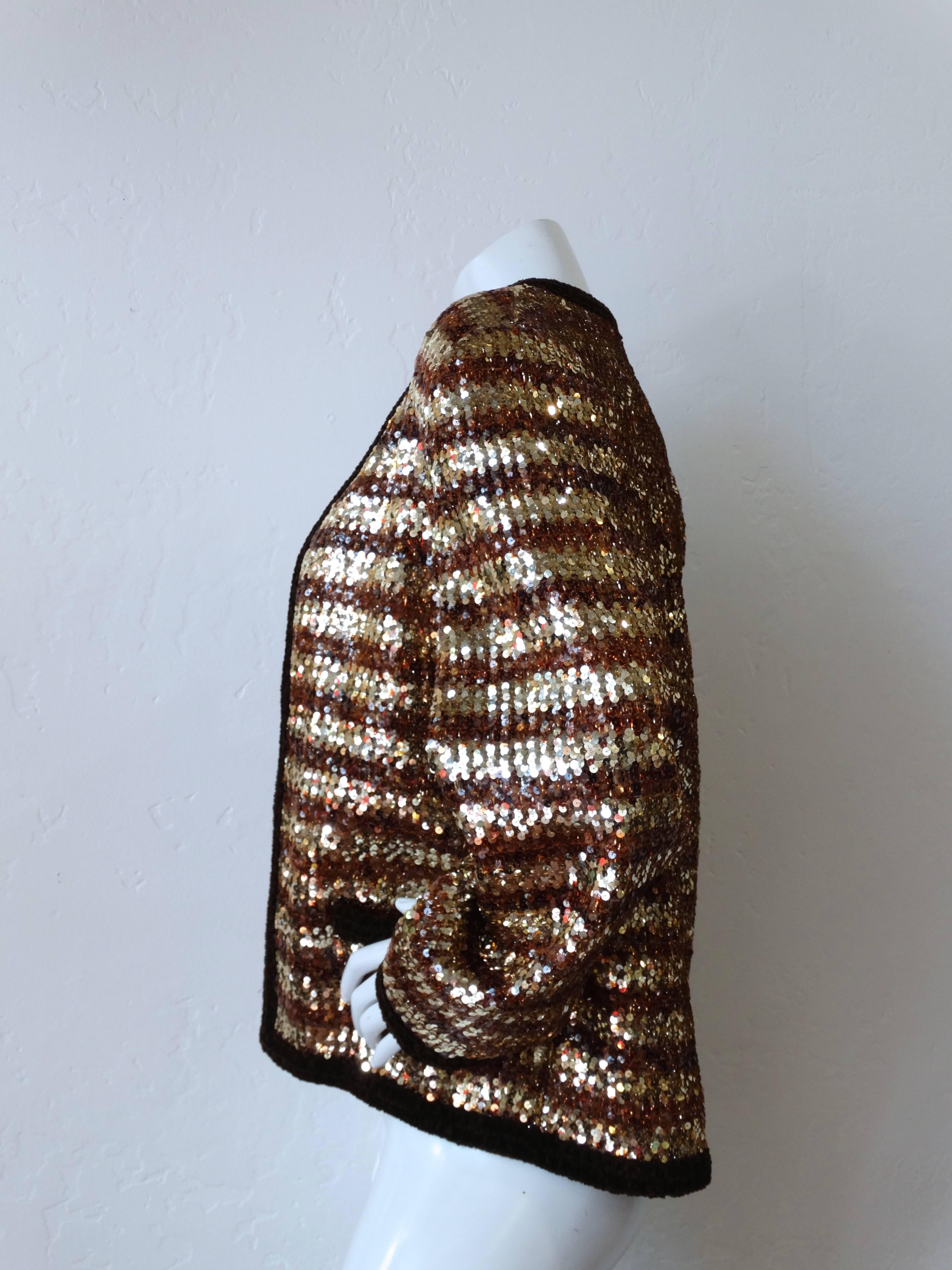 Fabulous 1980s Givenchy two-tone  Sequin Stripe Jacket. Copper and gold sequin fabric with velour knit trim. Pockets at either side of the waist. 

Measurements 
Bust: 19 - 21inches flat across from side seam to side seam
Waist: 21 inches flat