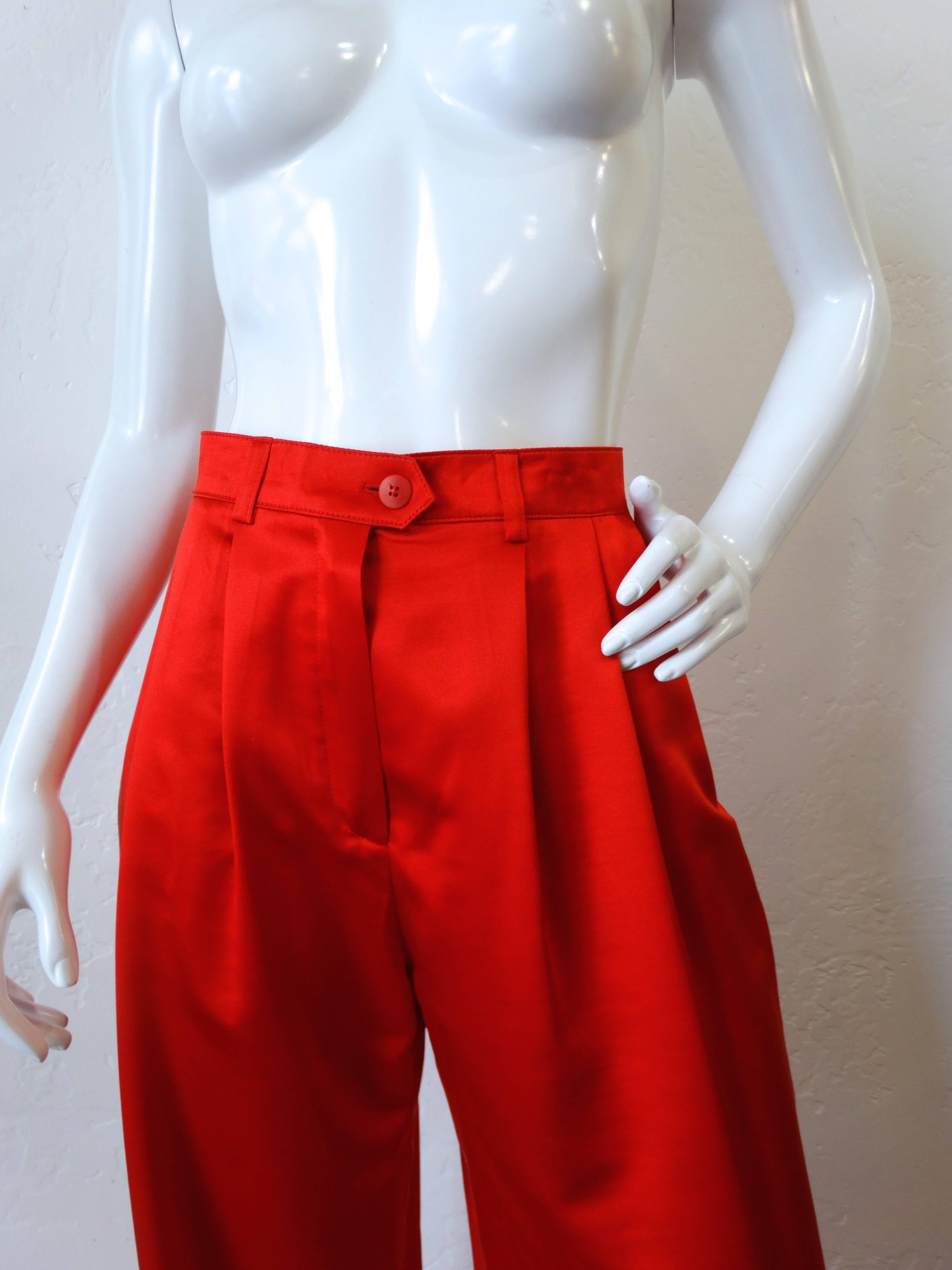 Amazing pair of Escada Couture lipstick red silk-blend  trousers. High rise waist with a wide leg fit. Small pull in the fabric on the right thigh, no larger than an inch in diameter. Marked a size 42. Inseam 34 inches 
