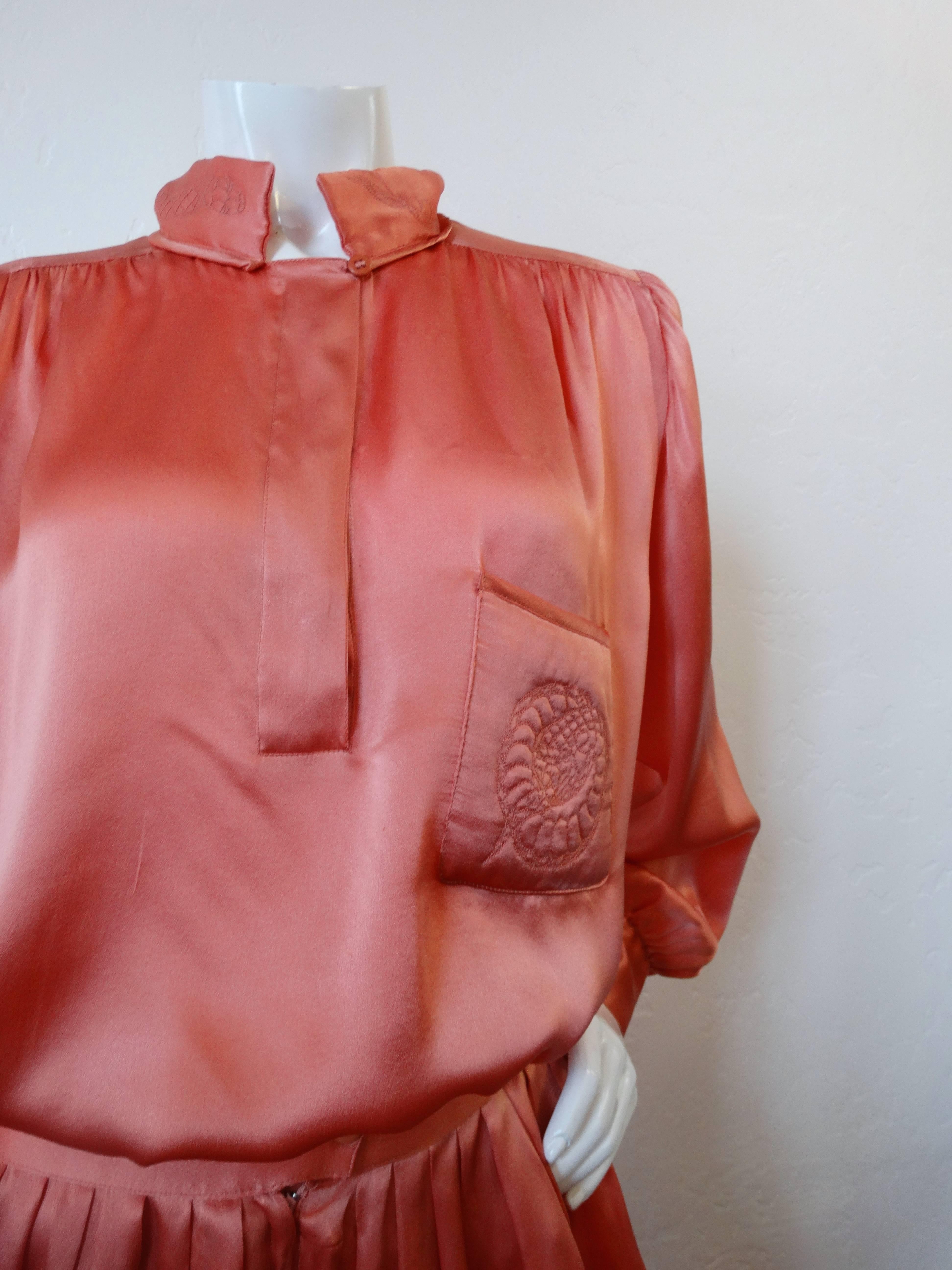 Incredible 1980s Krizia coral silk set. Snake quilted embroidery on the pocket and neckline of the blouse. Pants are high waist hammer style that tapper into a cigarette cut. Some light discoloration on the pant leg, see last detail shot.