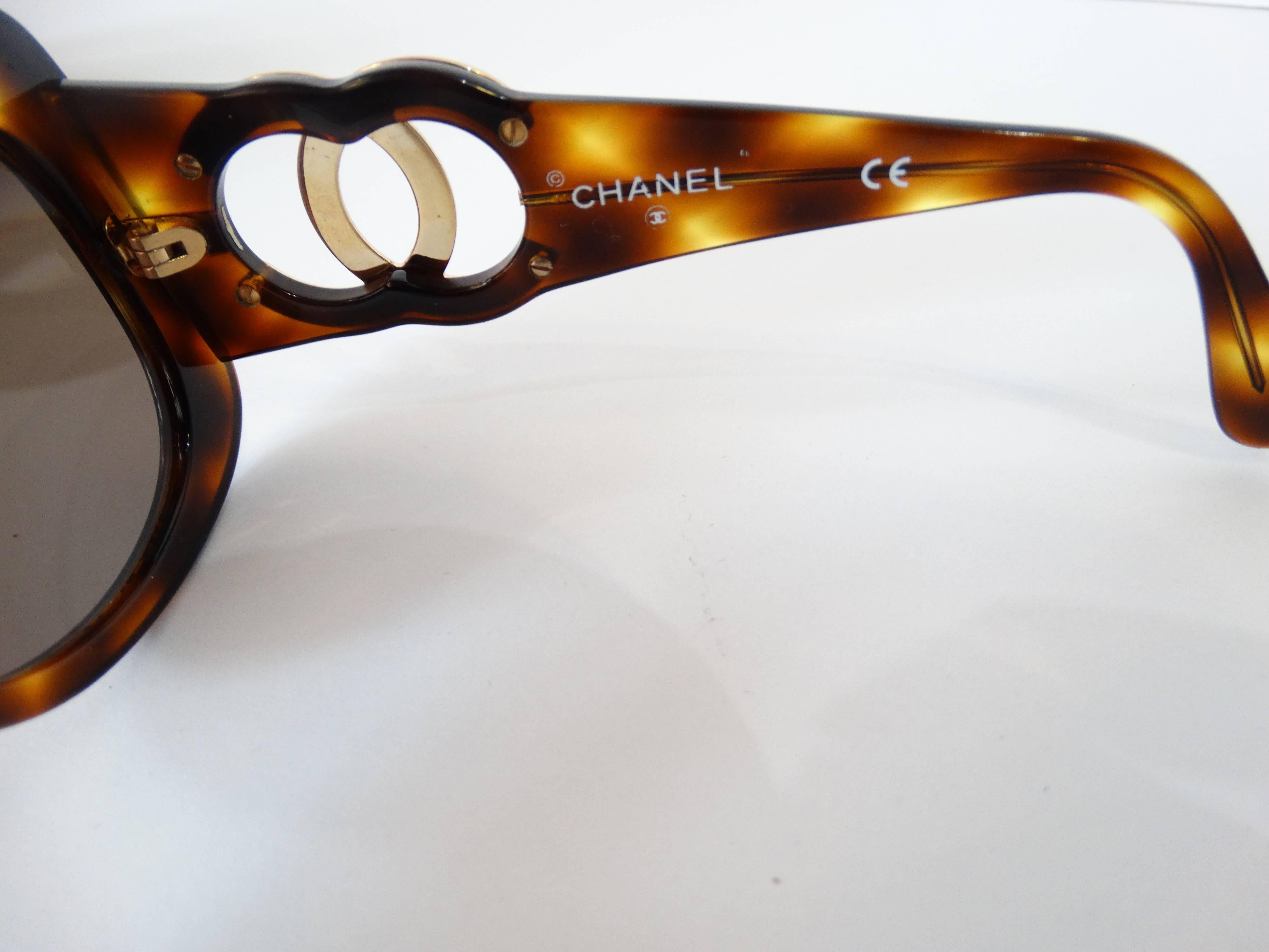 Fabulous 1990s Chanel Tortoise Shell Sunglasses. Mod square shape. Signature Chanel Logo in gold at either arm.Width of glasses from temple to temple is 5 inches. Some of the print on the inside has faded off, part of the id number (first 5 digits)
