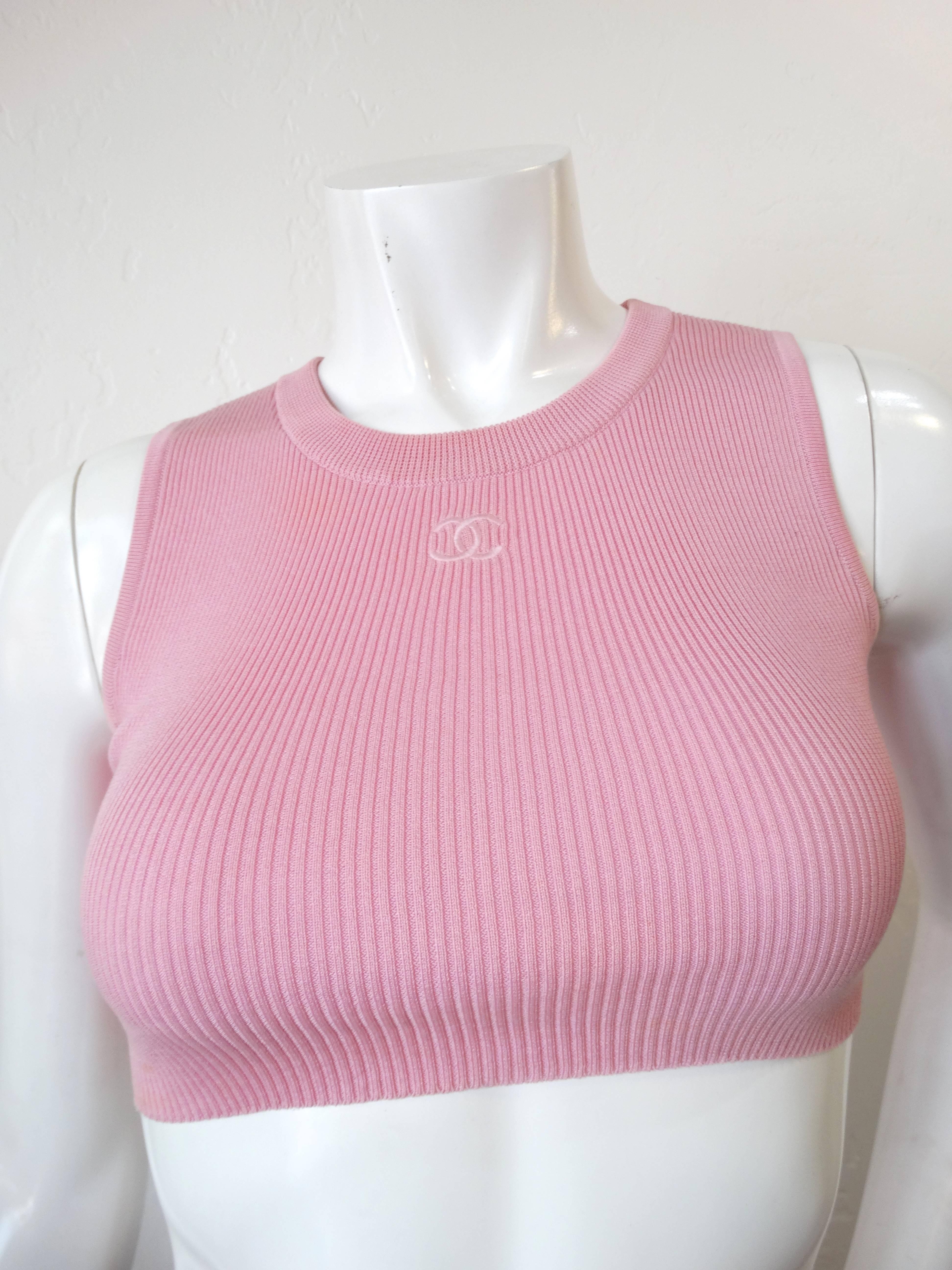 Incredible Chanel crop top made in 1995! Sleeveless with super cropped fit. Stretchy baby pink cotton knit fabric. Signature Chanel logo embroidered at the neckline. Marked a Size 36- fits about an XS. 

Some light discoloration along the sides,
