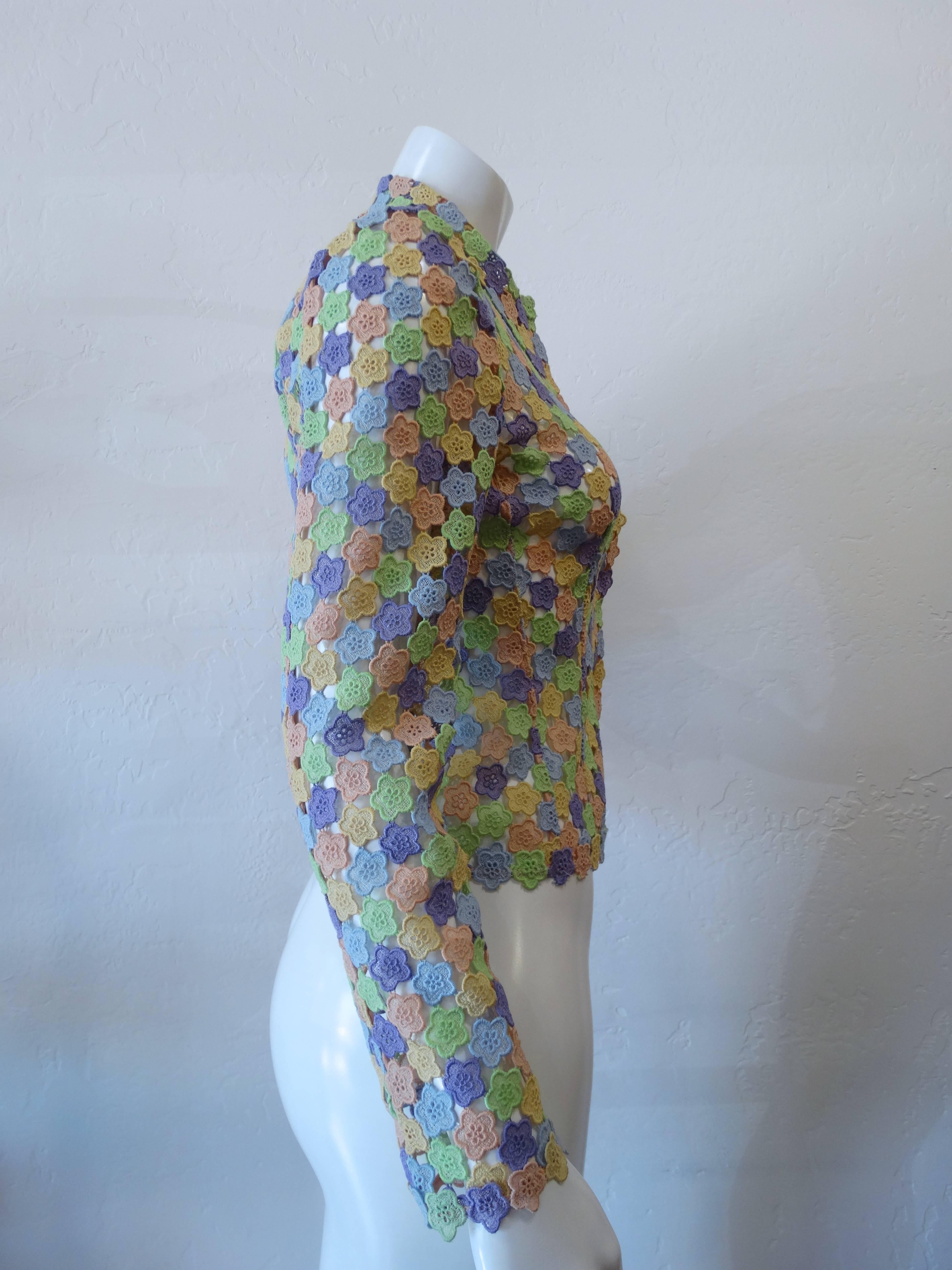Late 1990s Moschino Cheap & Chic pastel floral blouse jacket. Pastel multicolored sheer floral fabric. Pointed collar neckline. Snaps up the front. Marked a size US 6, fits about a small/medium. 

Sleeve 24