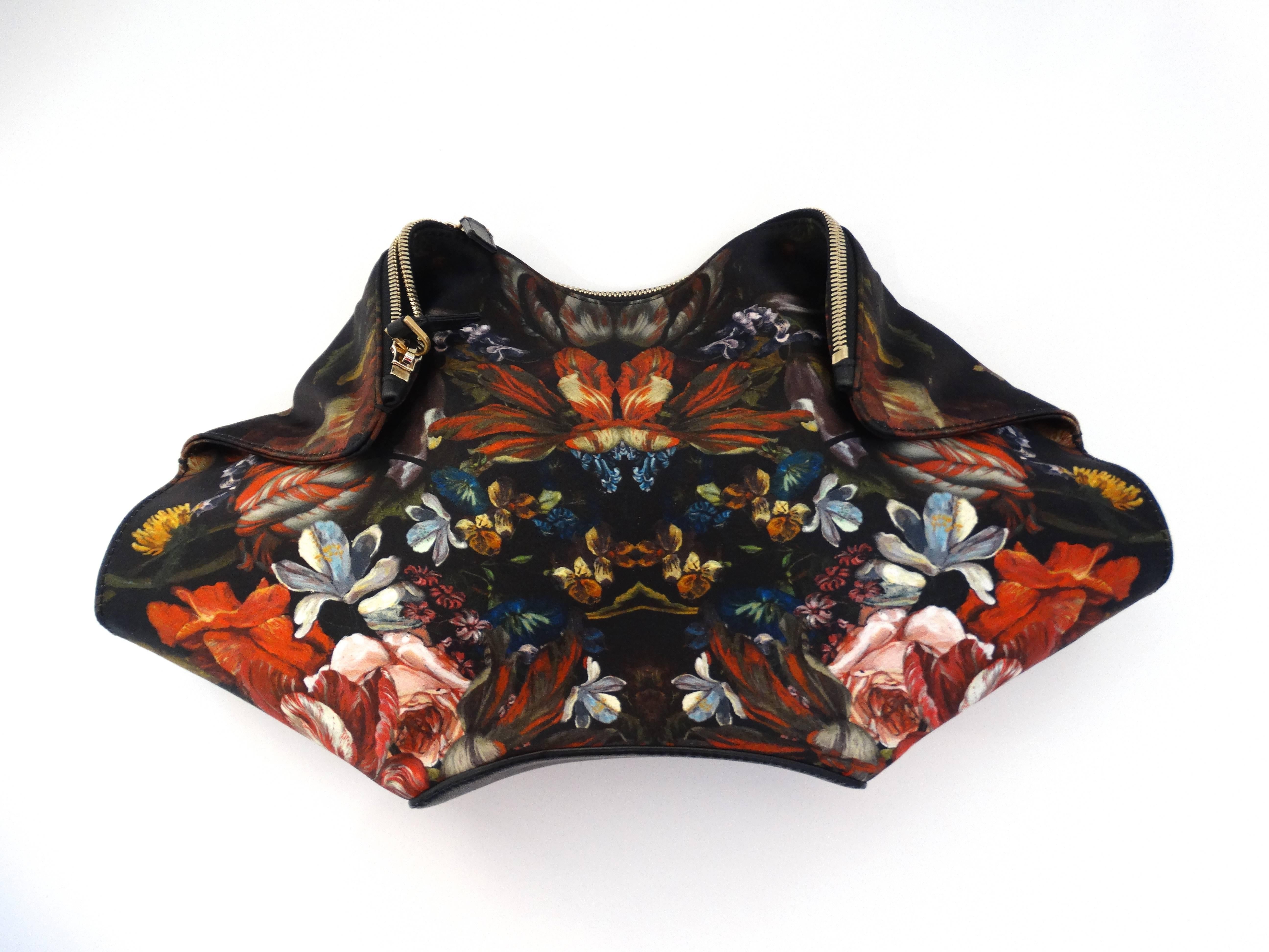 Incredible silk satin Botanical printed Alexander McQueen De Manta Clutch. Magnetized folds at either side. Unzips along the top. Fully lined interior with zip pocket Goldtone hardware. 15