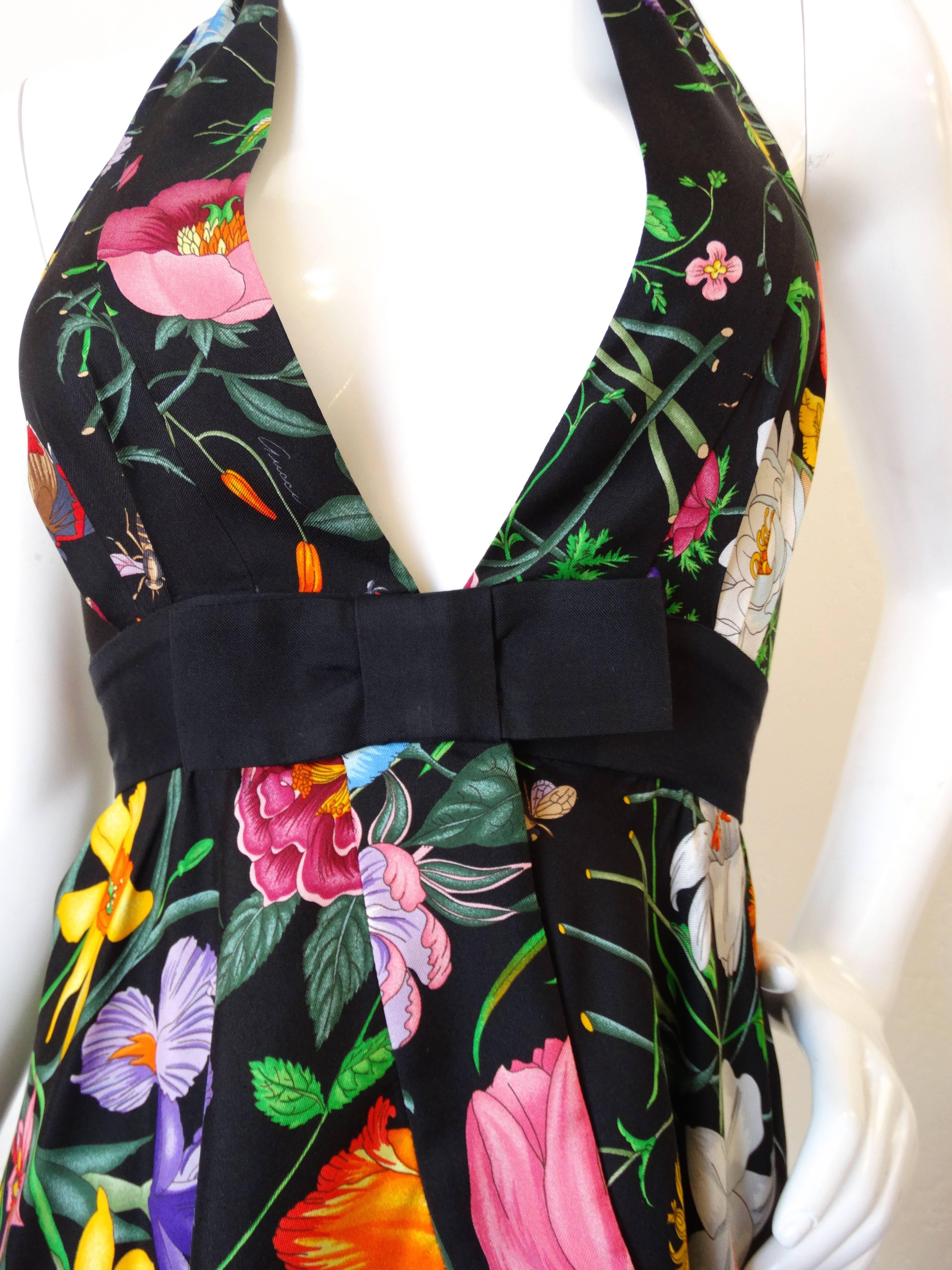 Late 1990's Gucci floral printed halter top! Snap closure beneath the black bow detail just below the bust. Ties at the neck. Halter fit allows for a range of bust sizes, best fits a small. Marked a size 38 Made in Italy 