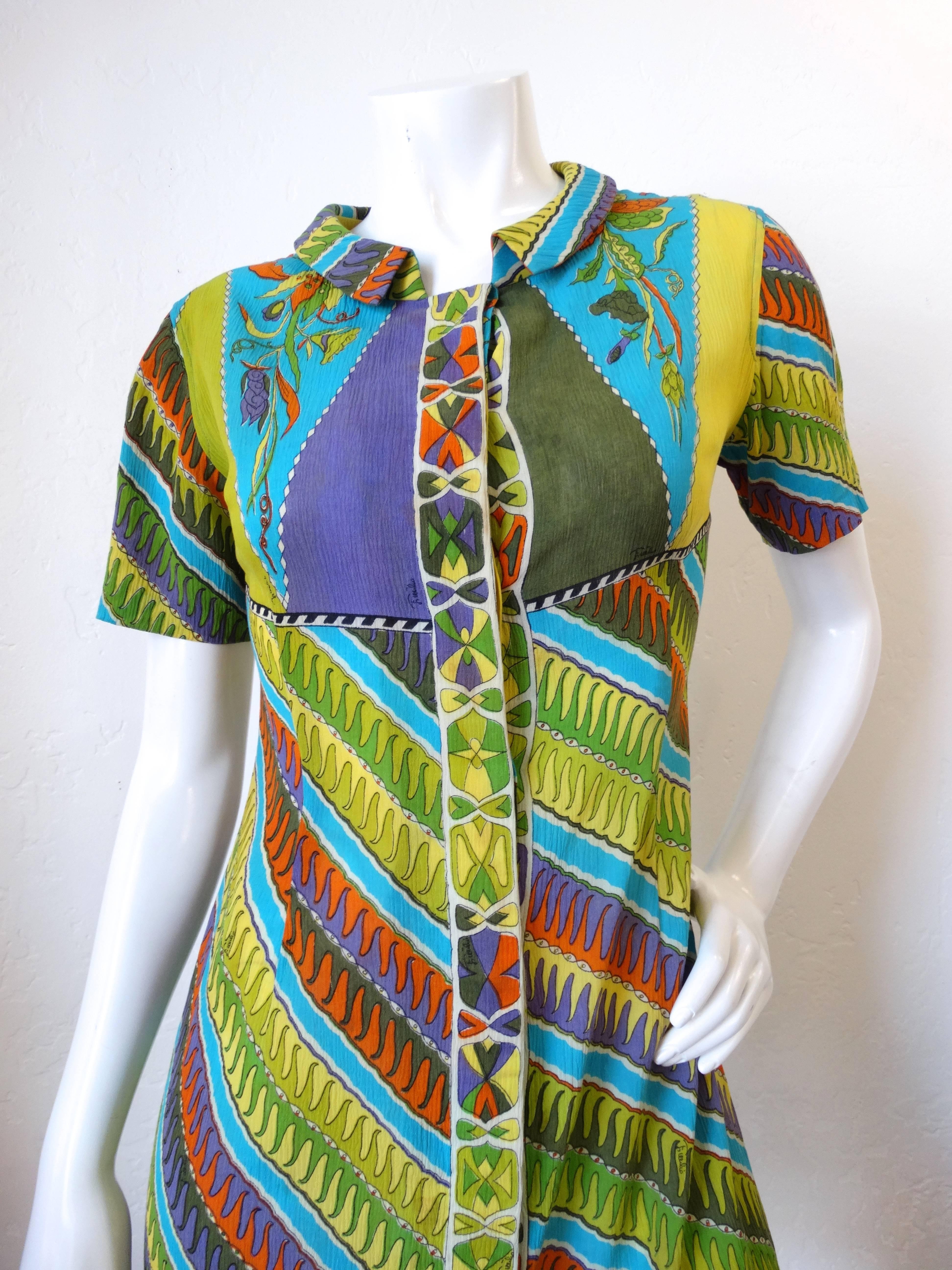 Incredible timeless 1960's Emilio Pucci Printed Mini Cotton Dress! Graphic geometric stripe iconic multi colored print. Buttons up the front with snap closures at the neckline. Short sleeves, mini fit. 100% cotton marked size 12 on dress but vintage