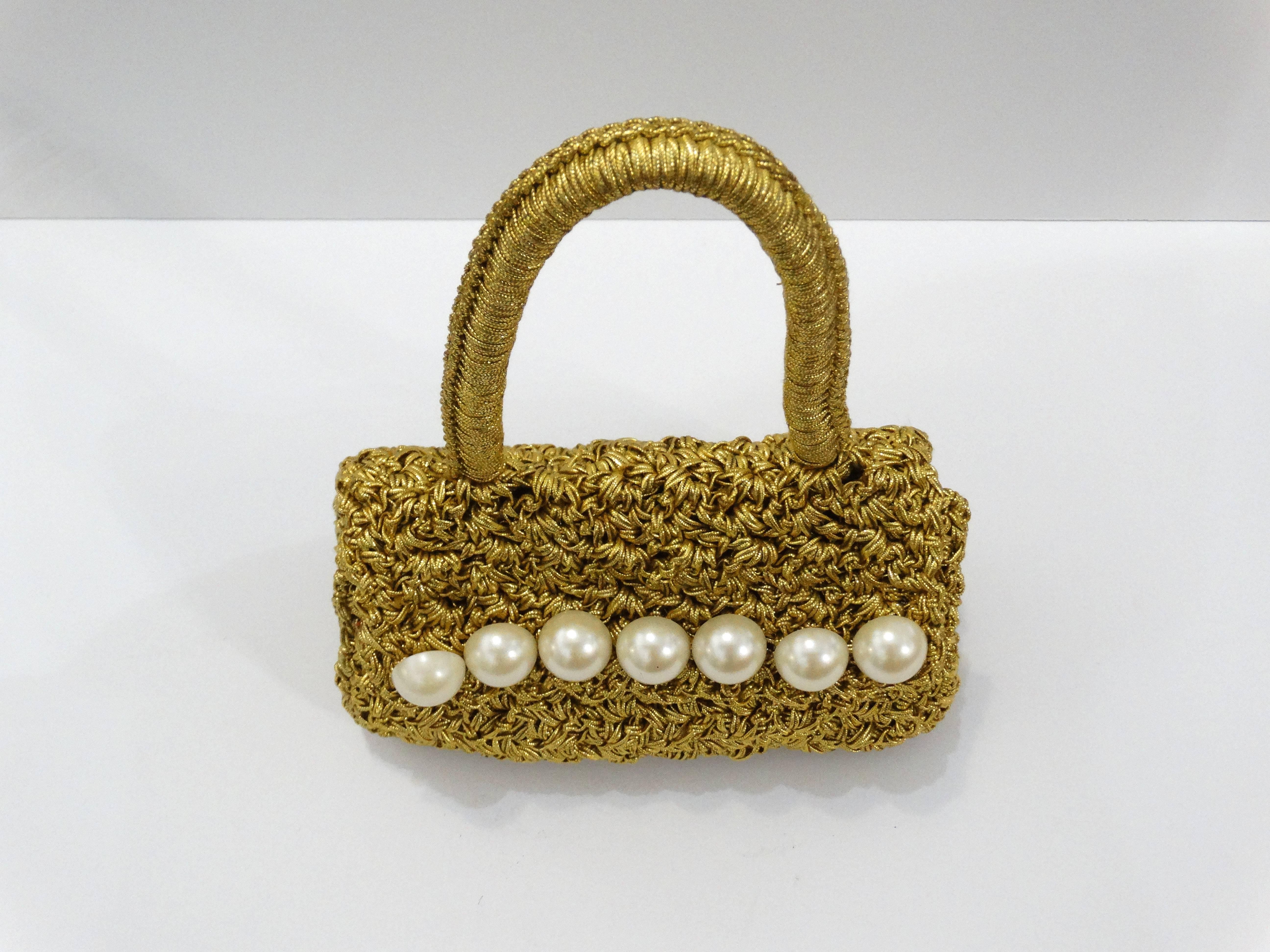 Gorgeous Carrie Forbes woven mini bag! Brilliant gold woven material accented with large faux pearls. Magnetic snap closures. Unlined interior. Will fit a large smartphone.

Measurements:

7