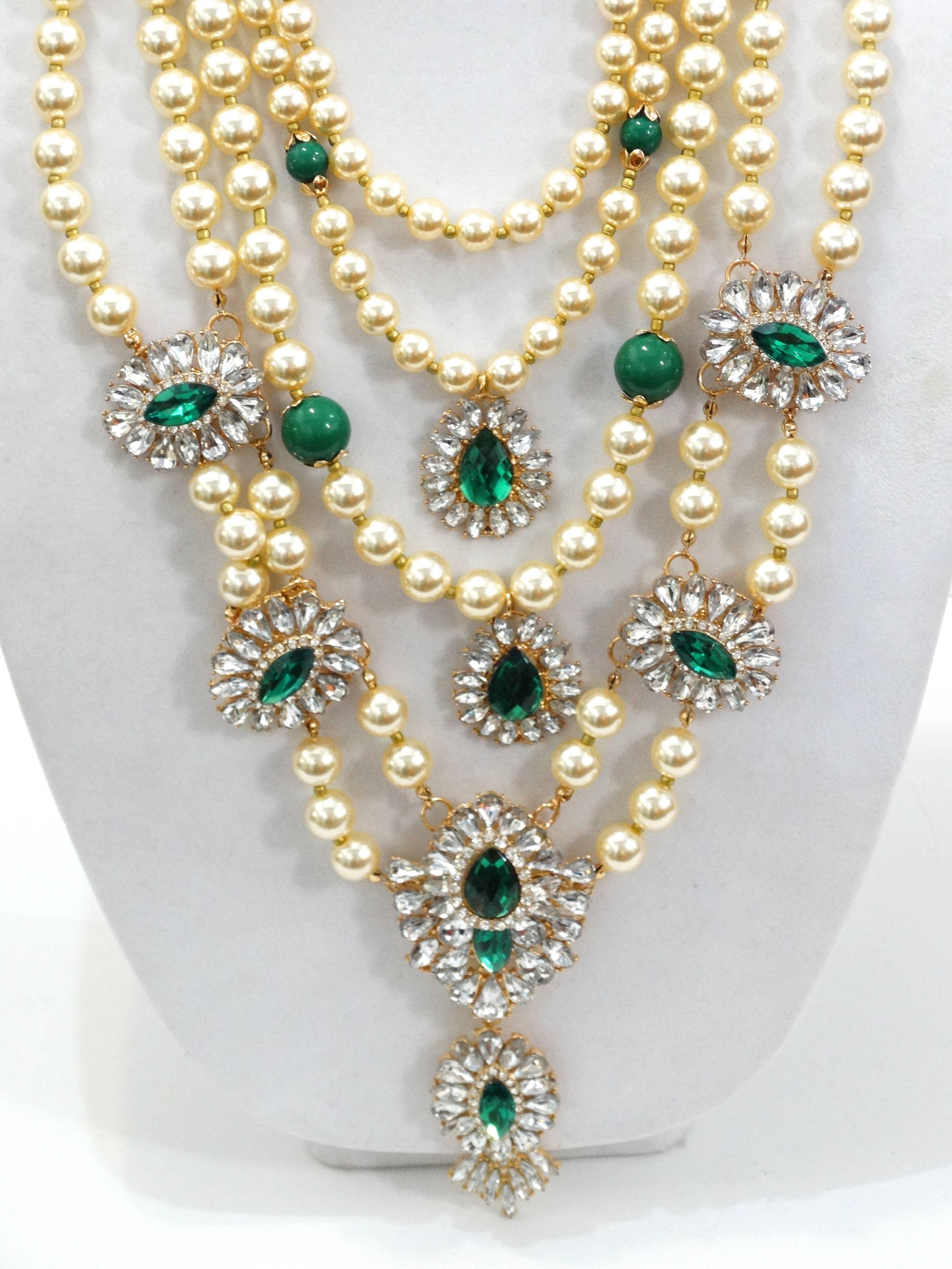 Make statements with this beautiful 1980s Courreges Faux Pearl 5 Layered Necklace. Each stran of pearls have a beautiful green accent, emerald glass rhinestones. Gold lobster clasp with signature Courreges 