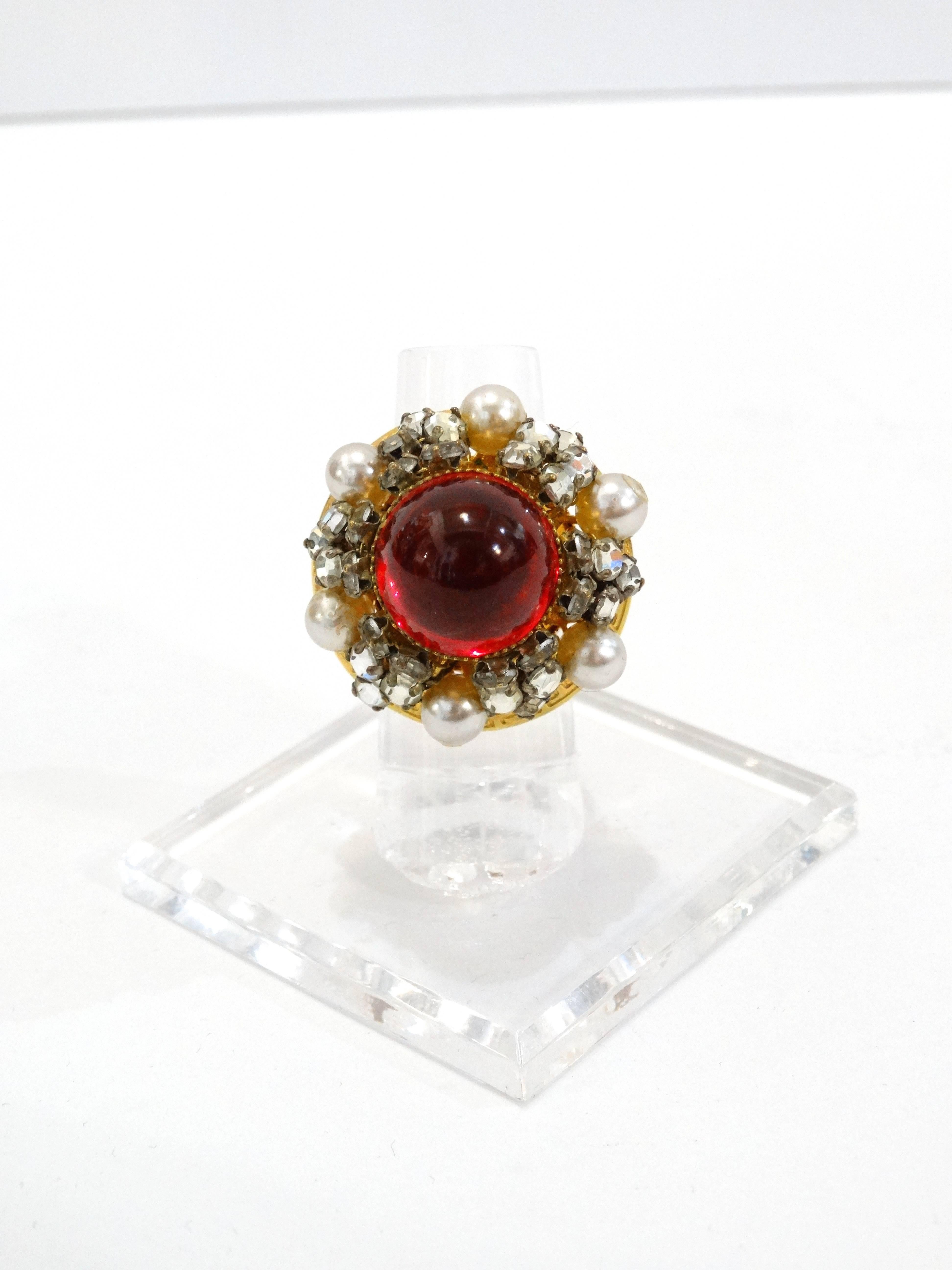 Incredible cocktail ring 1970s designed by William De Lillo! Rich gold metal with Greek key design, red glass center stone. Crystal and faux pearl details. Signed by De Lillo. One size for all 