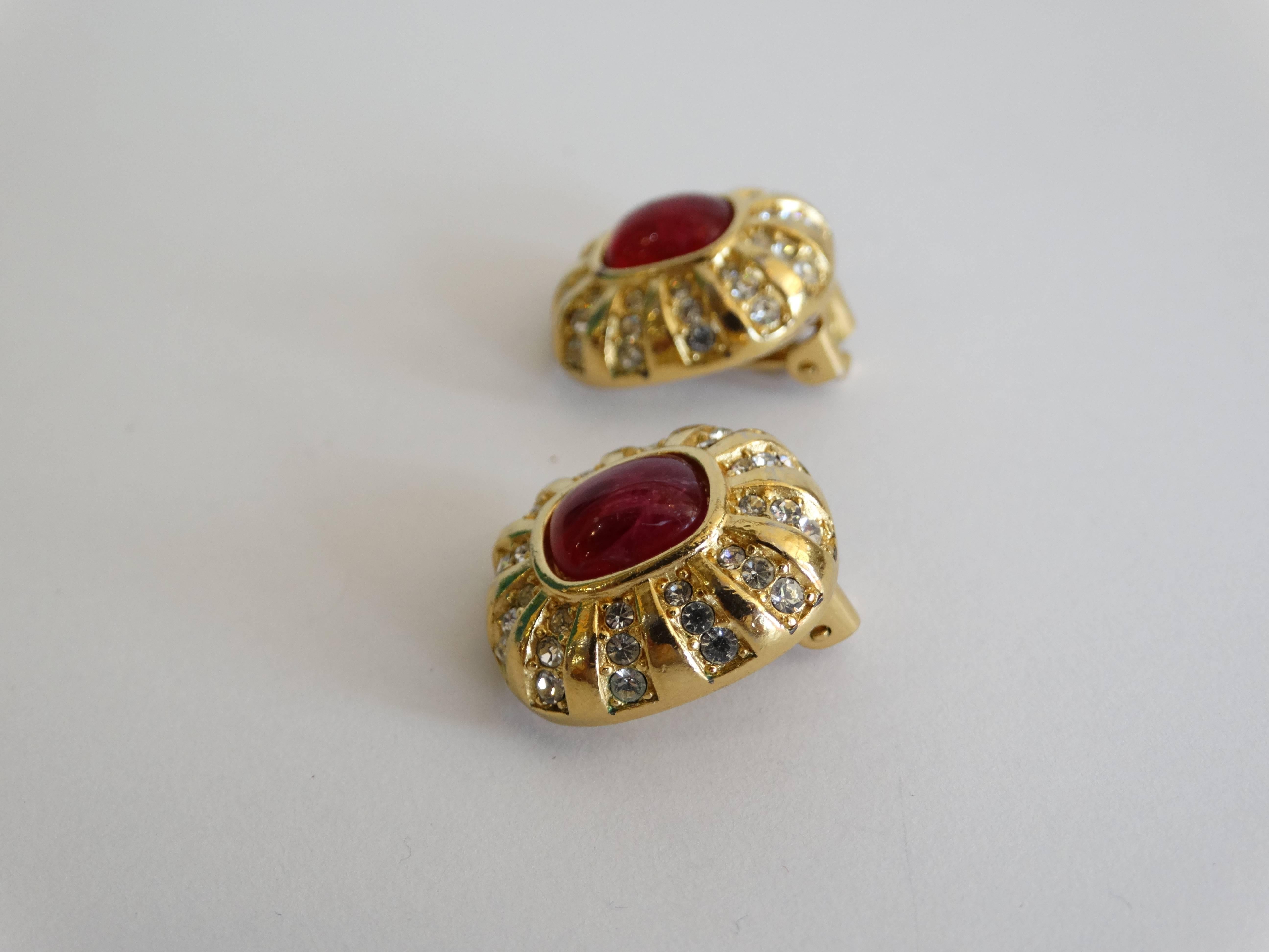 A beautiful pair of 1980's Christian Dior studded clip earrings with red cameo glass center stones, surrounded with a crystal sunburst design, Marked Chr.Dior 
plated gold made in France 

Measurements:

1