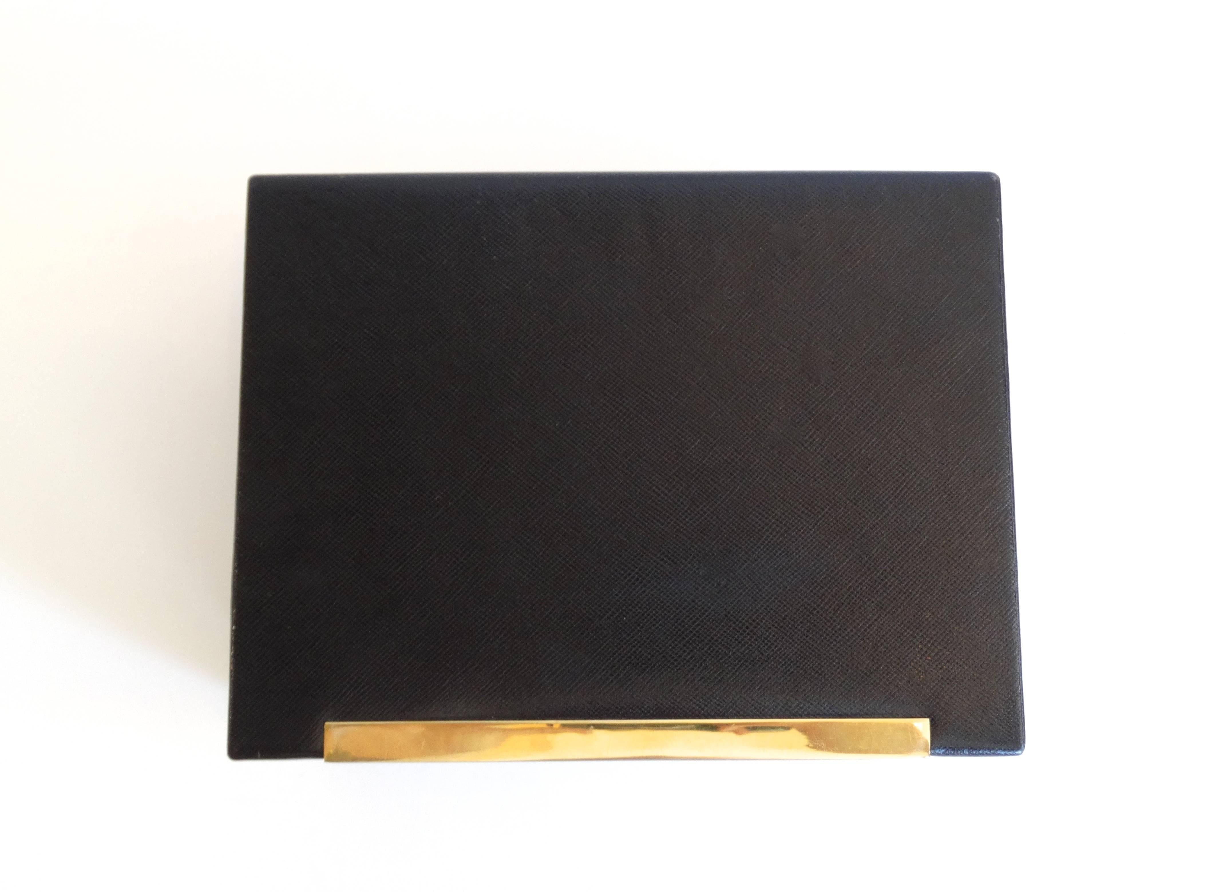 Fantastic 80's Black leather Gucci jewelry box! Comes with Gucci logo gold key. Removable tray in the bottom, features ring displays at either side. Tan suede interior. Some light wear- visible in the detail shots. made in Italy by GUCCI' embossed