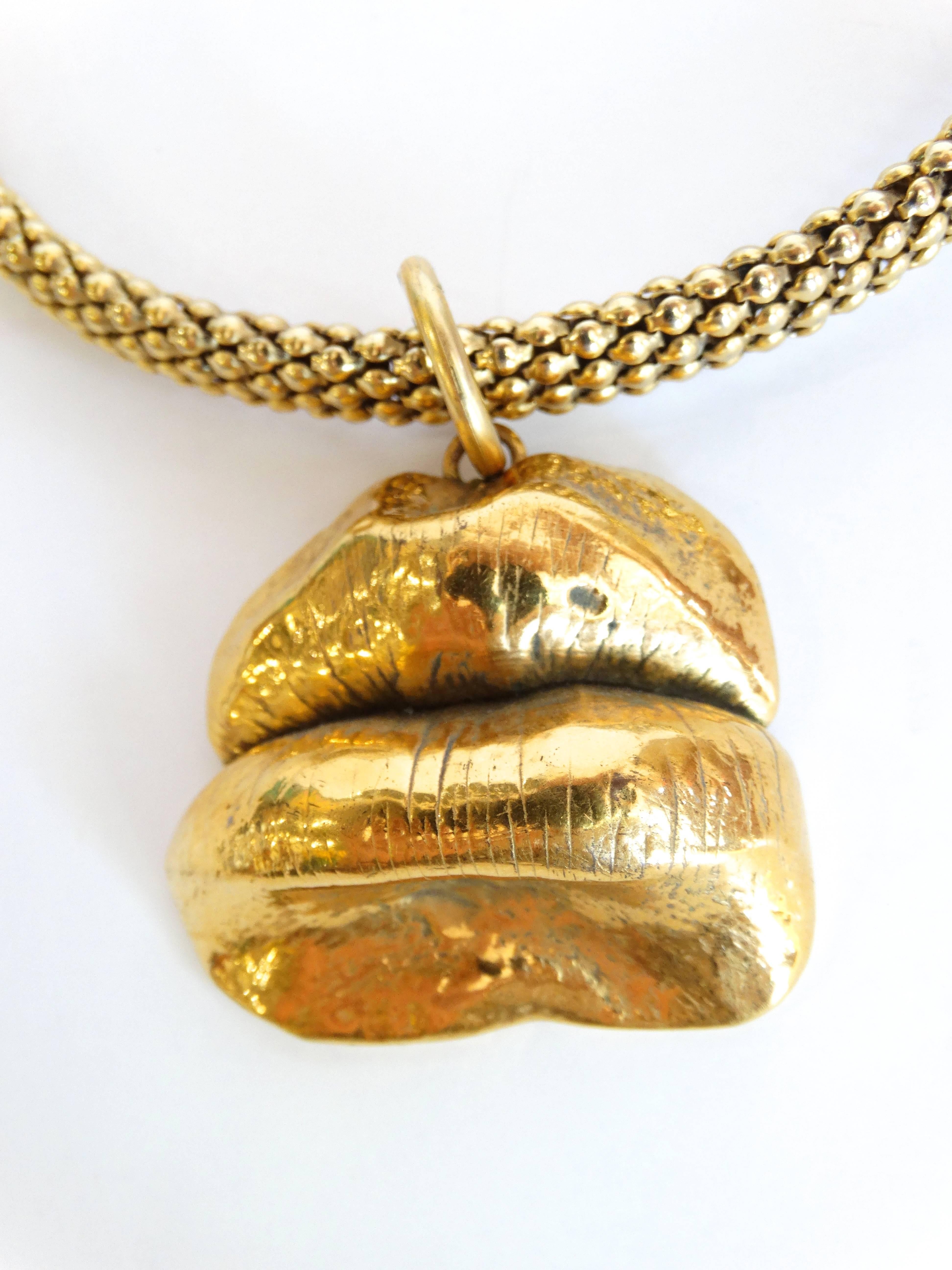 This piece is one of a kind- this is an actual pair of lips cast in gold metal. Attached to a gold collar necklace lips are Signed on the back with the Initials EA. Unknown designer piece 